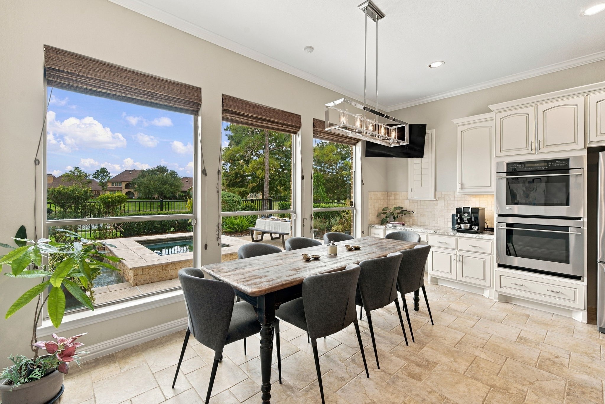 Oversized windows frame pool and lake views from the casual breakfast area, which sits conveniently alongside the kitchen.