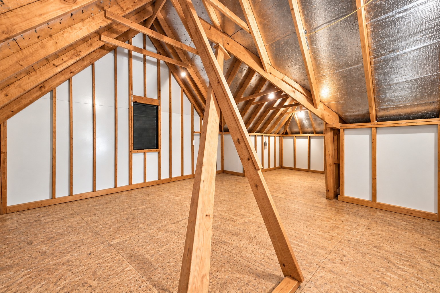 The walk-in attic offers floored storage space with lighting for convenient access and organization. This space can be built out as an extra living area in the future (if needed).