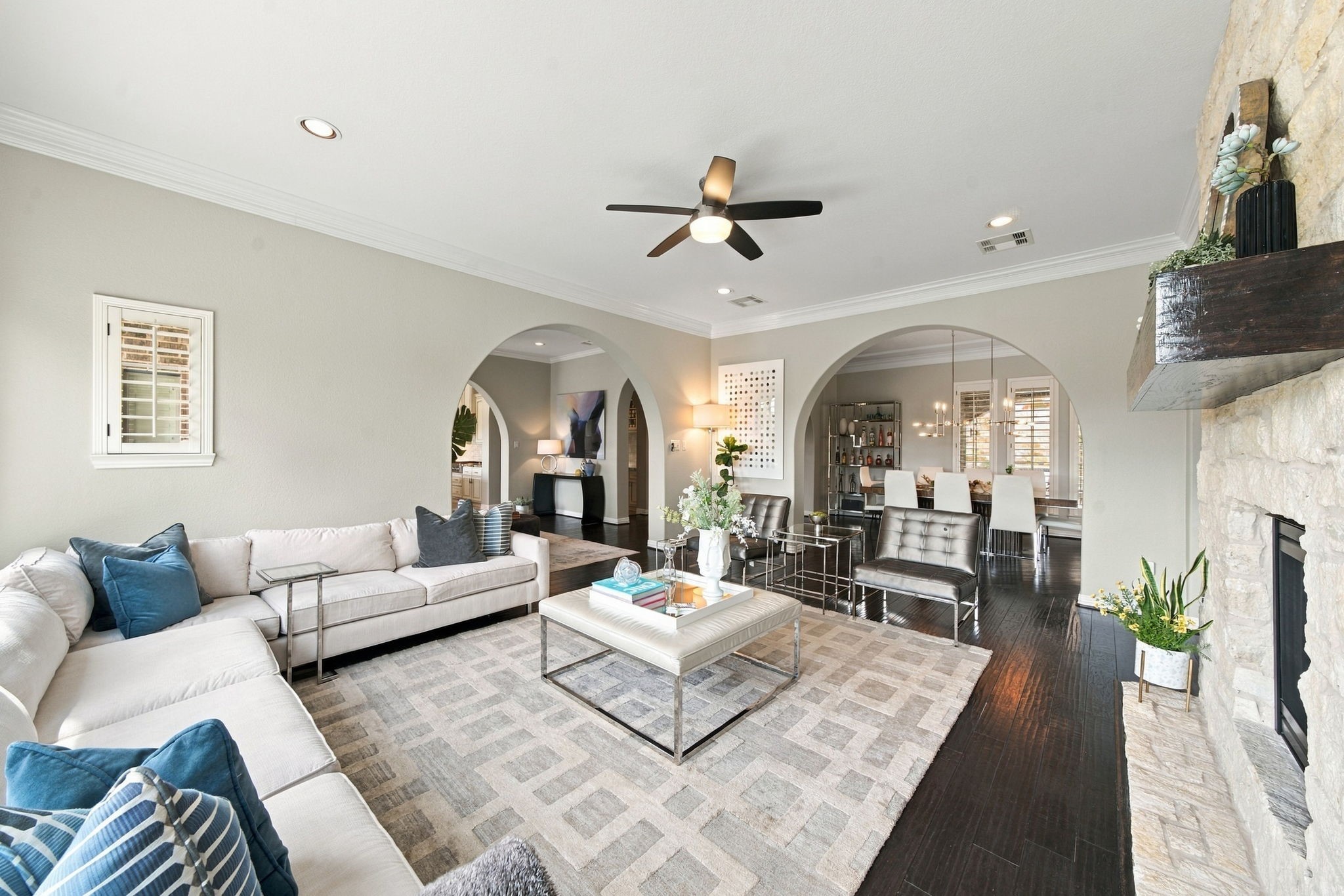 Another view of the living room highlights the beautiful arches flowing into the dining room