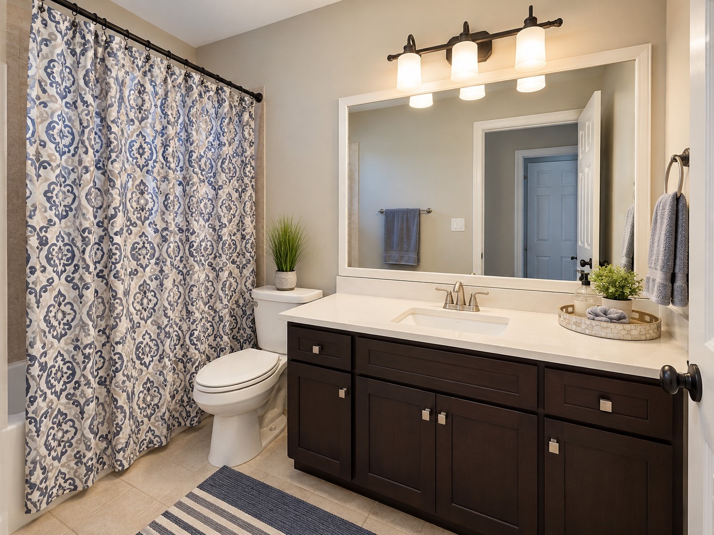 This secondary bathroom offers a full tub and shower combination and vanity storage.