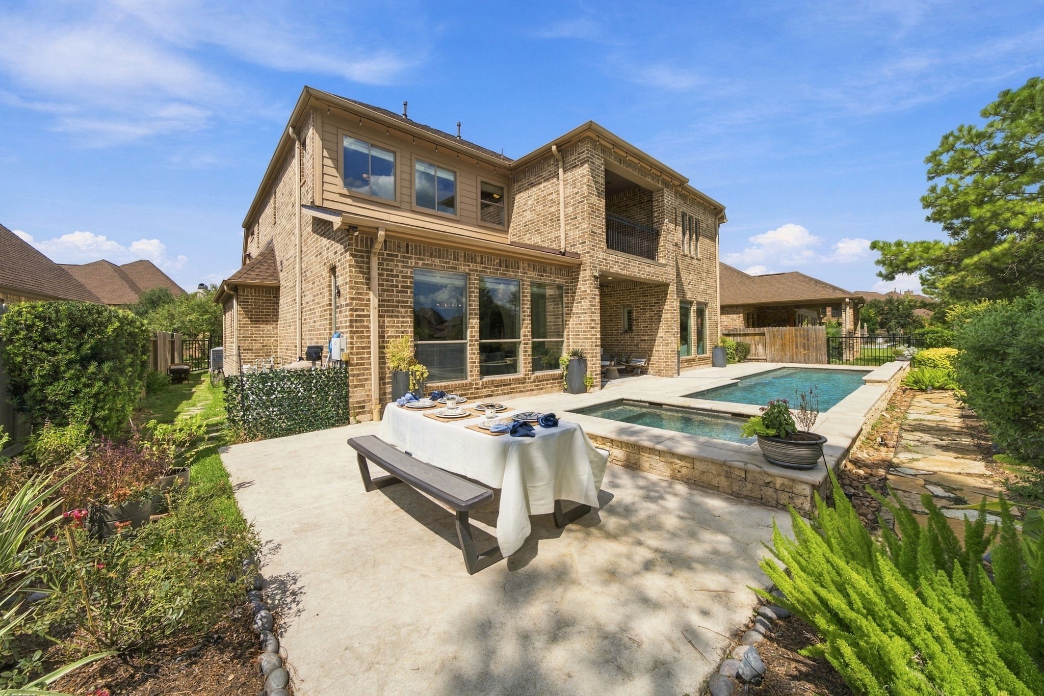 The landscaped backyard offers a pool and spa, generous patio space and multiple areas for outdoor dining and relaxation.