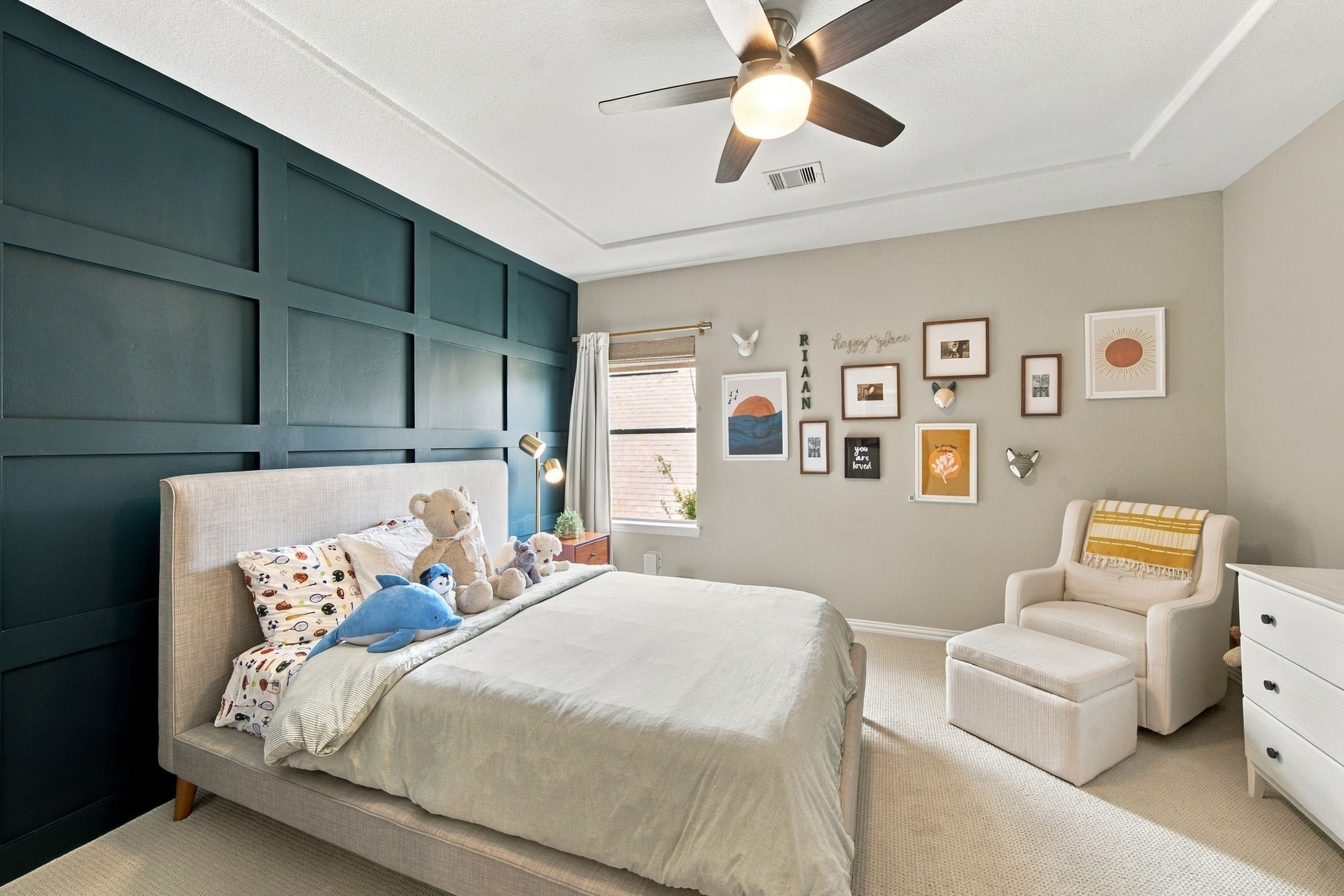 A distinctive paneled accent wall gives this secondary bedroom plenty of character.