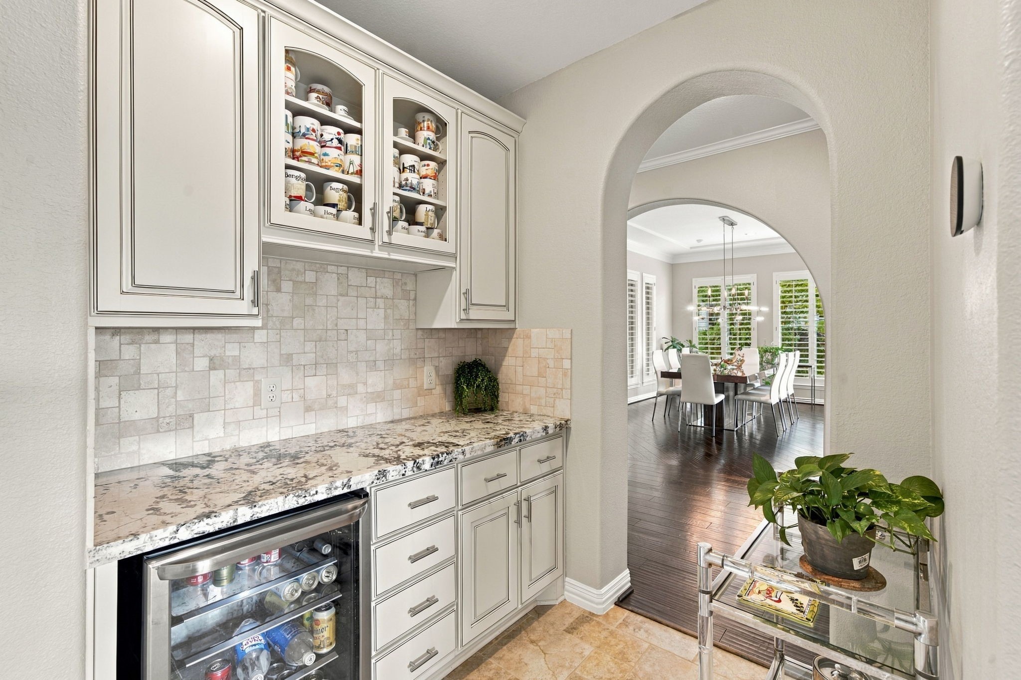 A convenient butlers pantry provides extensive cabinetry, a granite serving counter, display storage and a built-in beverage refrigerator.