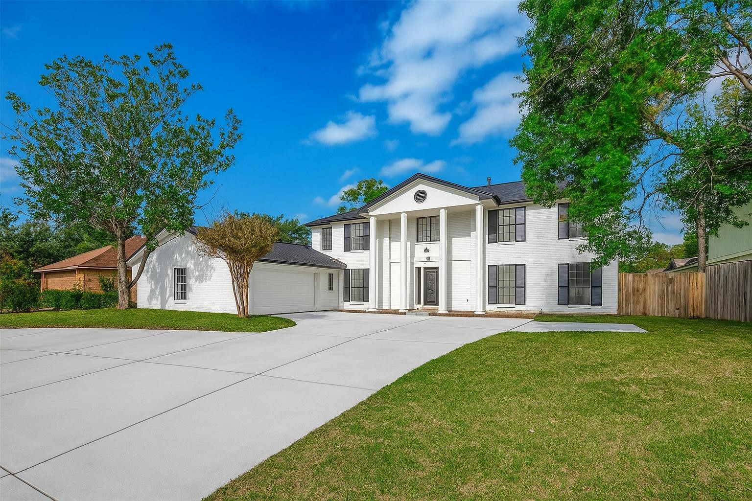 The property includes a large driveway, attached garage, and a well-maintained lawn offering a welcoming curb appeal. The property includes a large driveway, attached garage, and a well-maintained lawn offering a welcoming curb appeal.