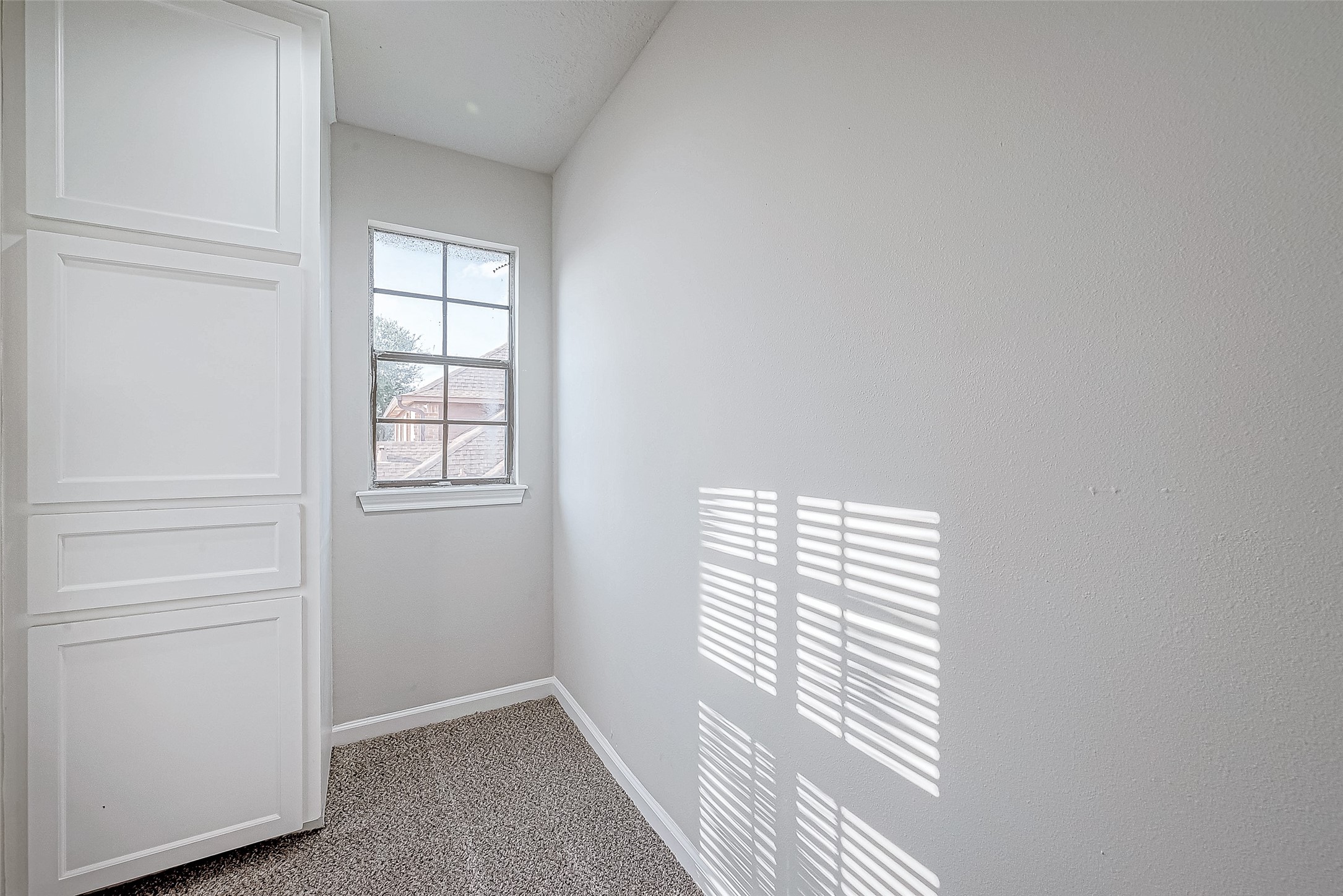 Built-in white cabinets for storage.
