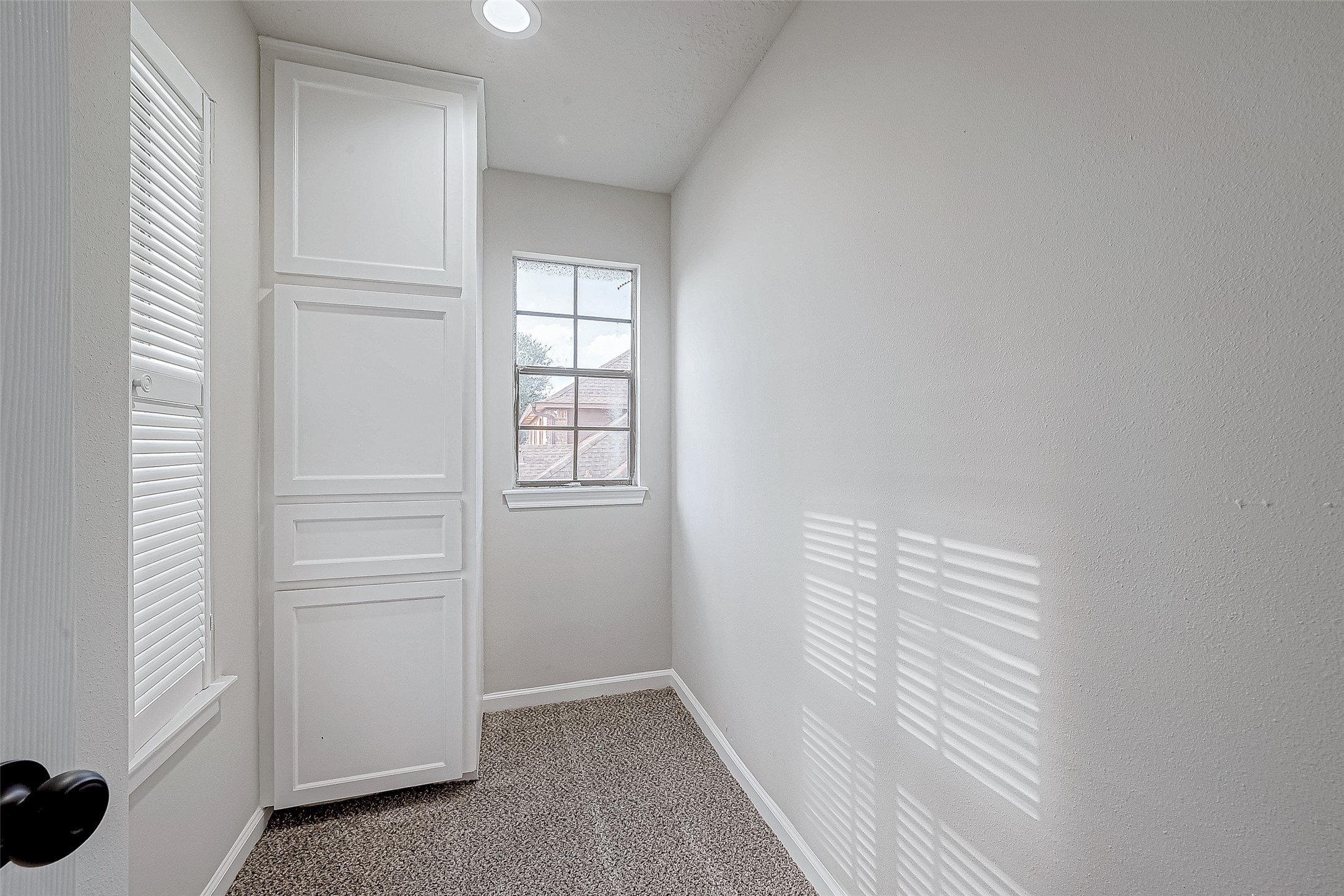 Built-in white cabinets for storage.
