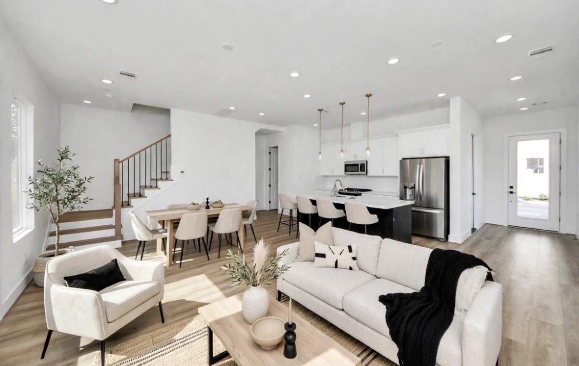 Open-concept living space with light floors and walls, accented by pops of black for a sleek, elevated modern look. The clean design and open layout create a bright, spacious feel. Open-concept living space with light floors and walls, accented by pops of black for a sleek, elevated modern look. The clean design and open layout create a bright, spacious feel.