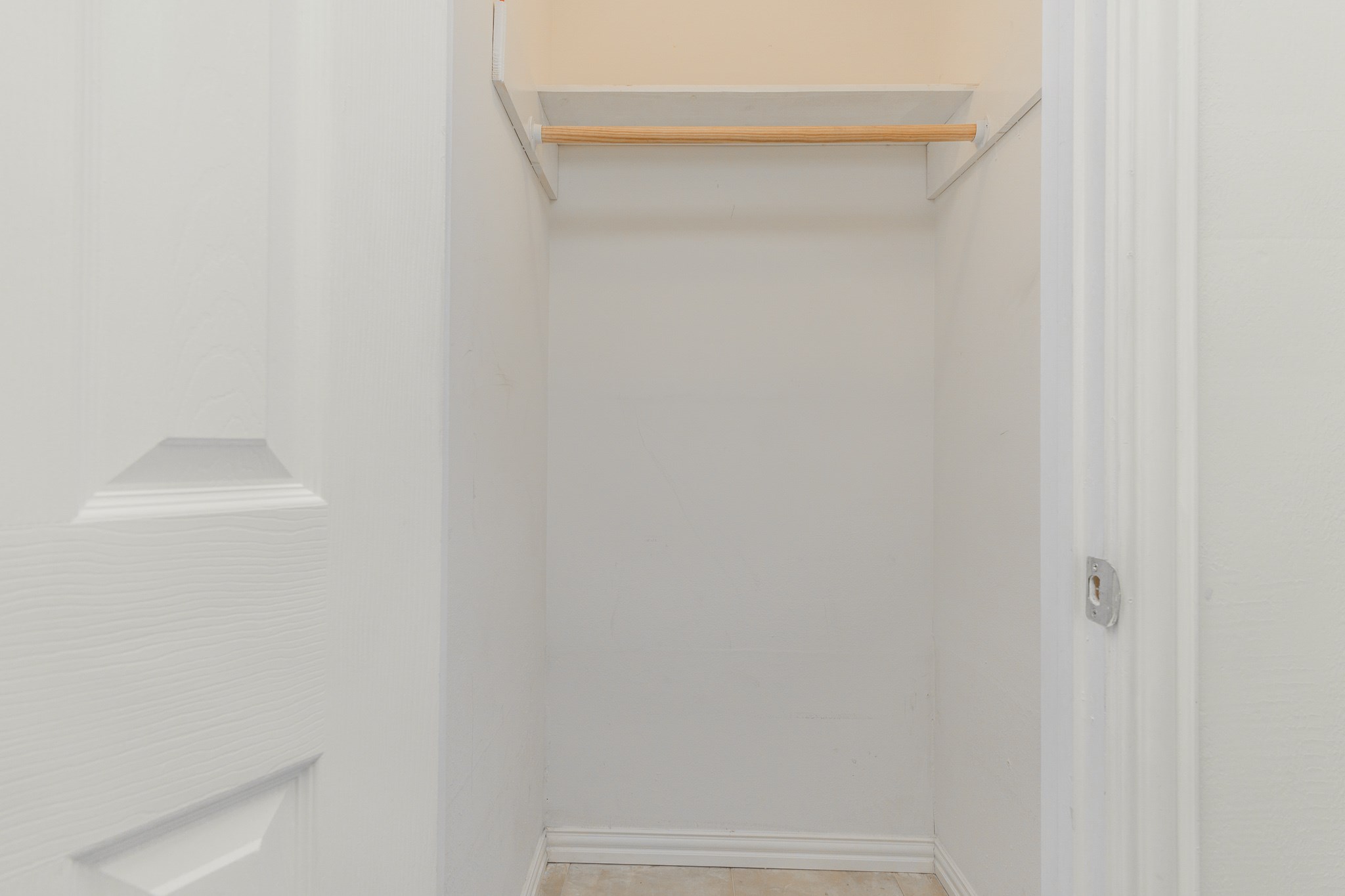 Walk-in closet located in the hall across from the bathroom.