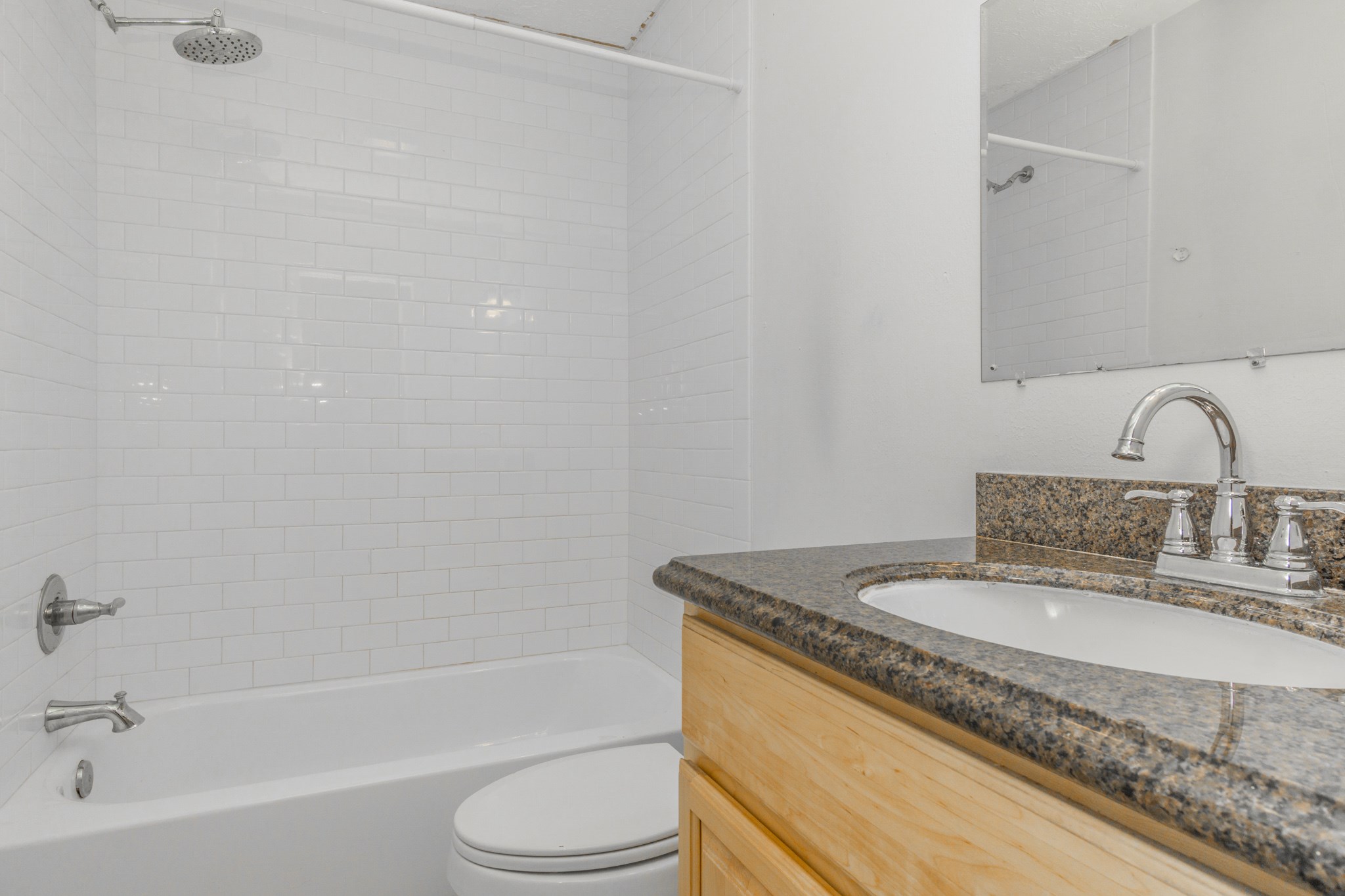 Bathroom located down the hall with a sparkling granite vanity