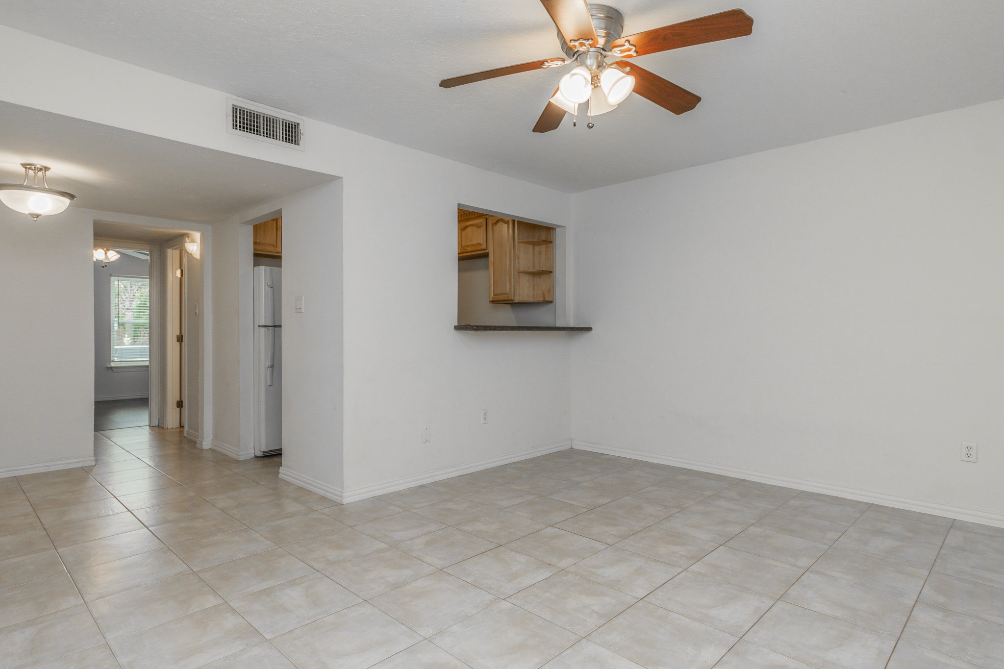 Once you walk in, you are greeted to an open living/dining area with easy-cleanup tile all throughout.