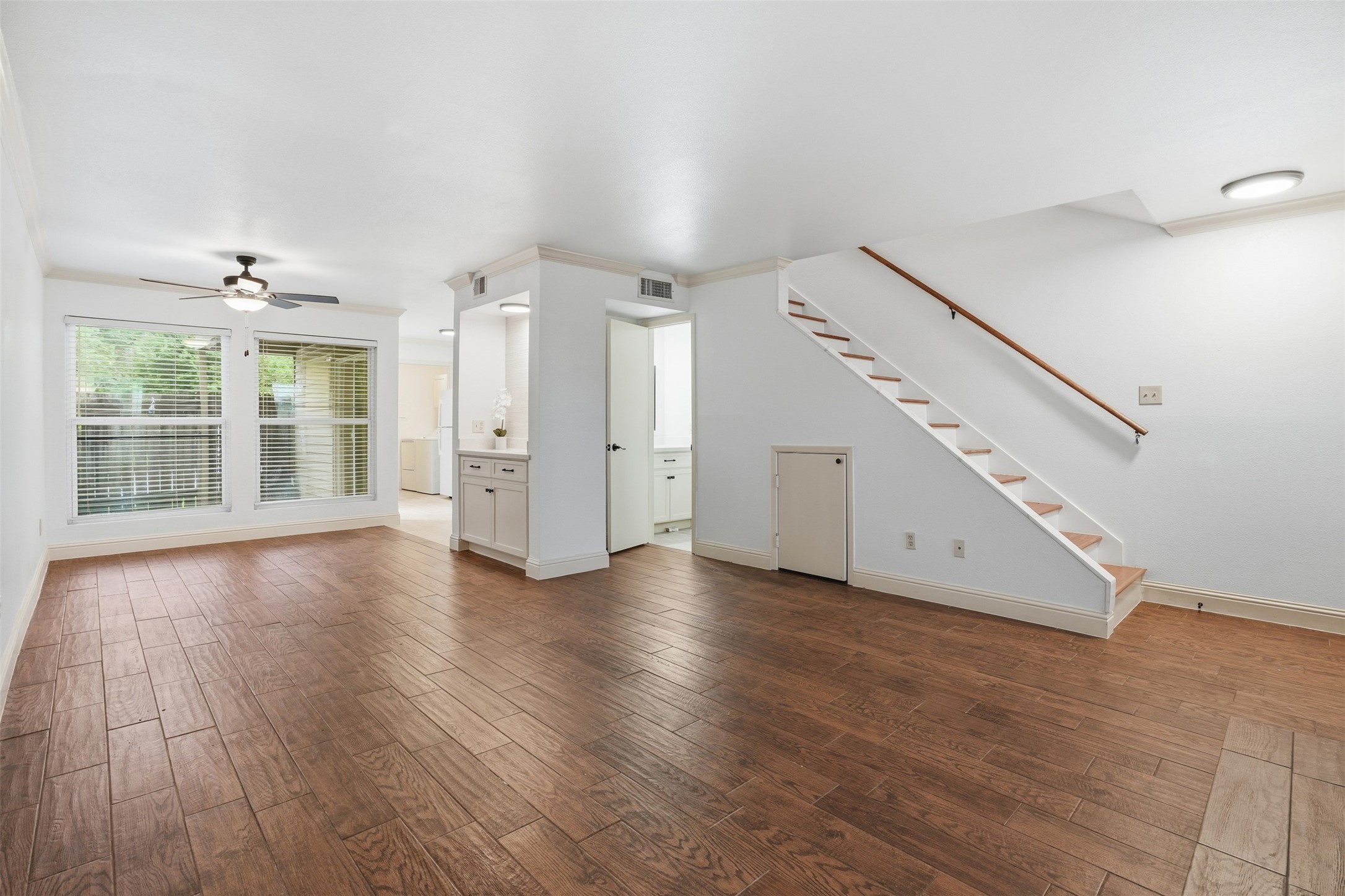 welcoming living space featuring an open staircase, and natural light.