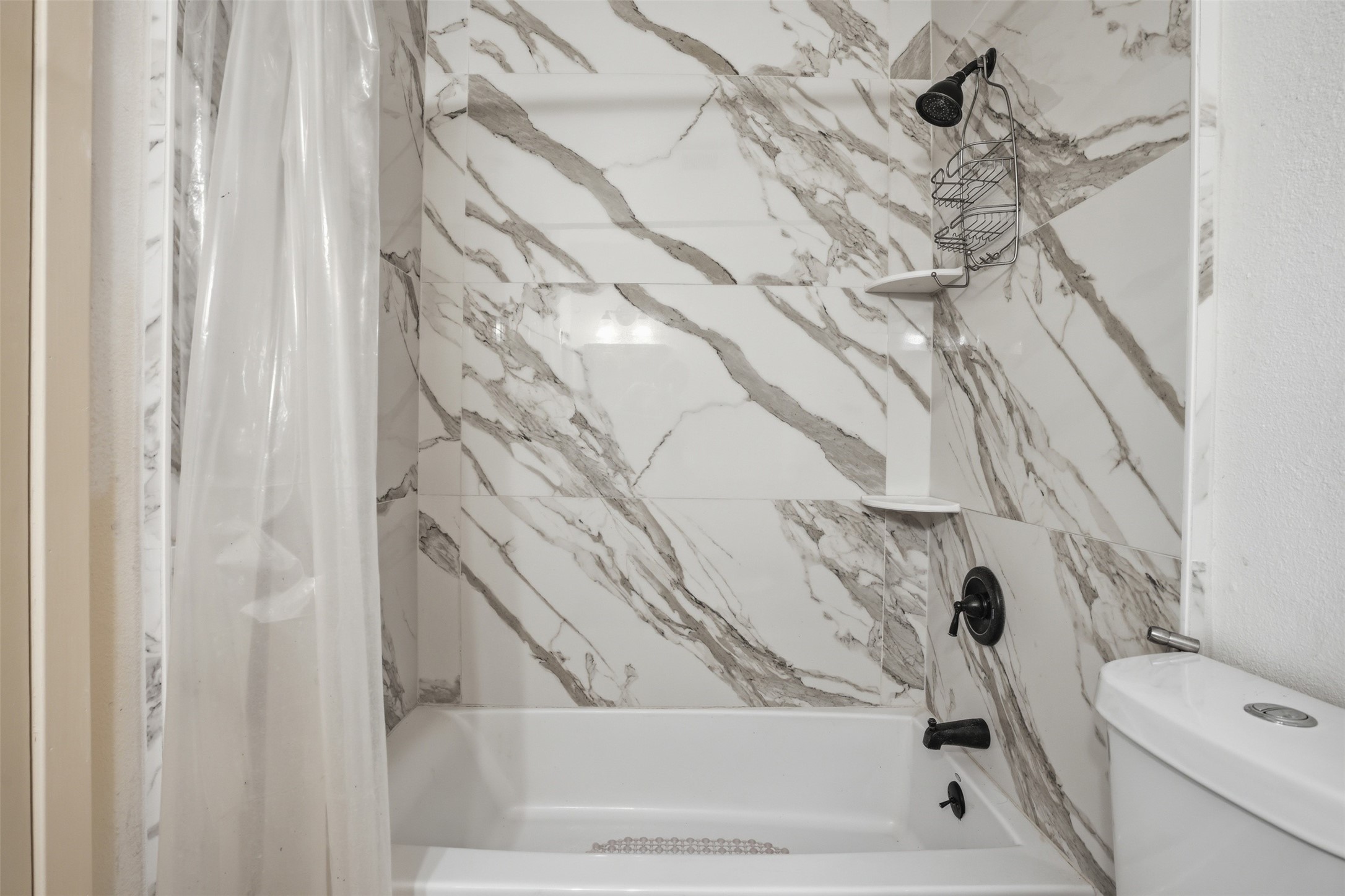 Beautiful tub/shower combination with built in corner shelves.