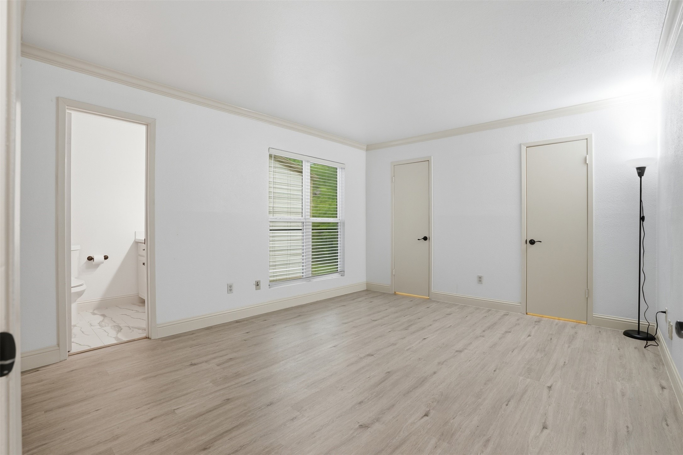 Spacious first Primary, beautiful crown molding throughout! Featuring two walk in closets, an es suit bath and an additional linen closet!