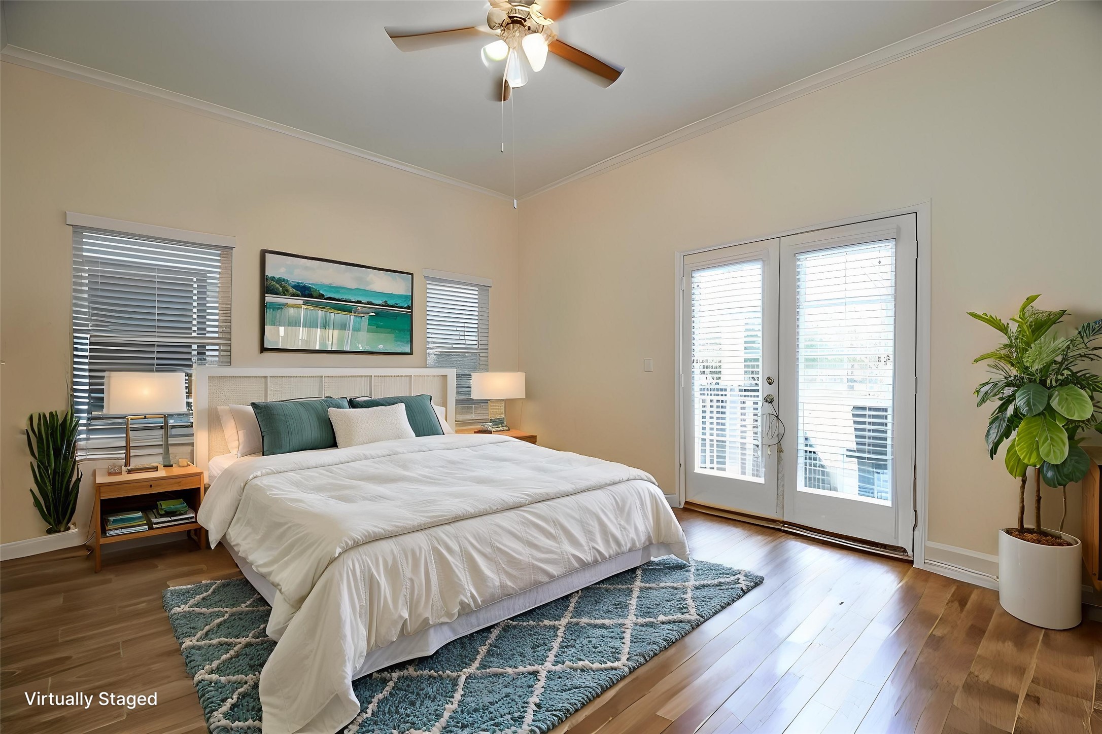 This spacious Primary bedroom located on the first floor. Natural light pours in through large double doors leading to a private outdoor space. Stylish decor and tile floors complete the inviting atmosphere.