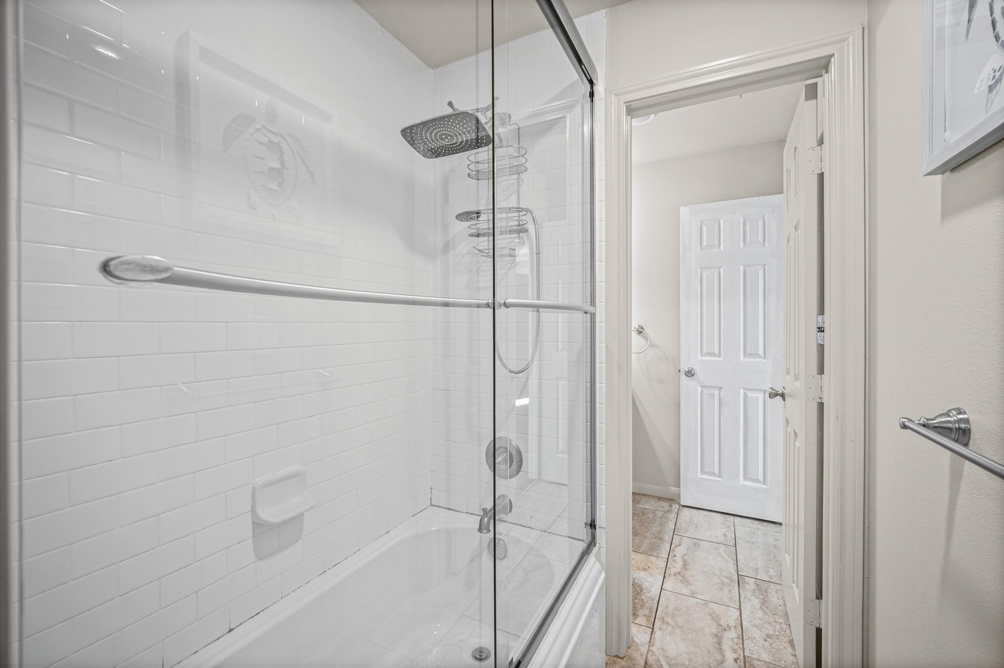 Spacious bathroom featuring a modern glass-enclosed shower with sleek fixtures and elegant tile flooring.