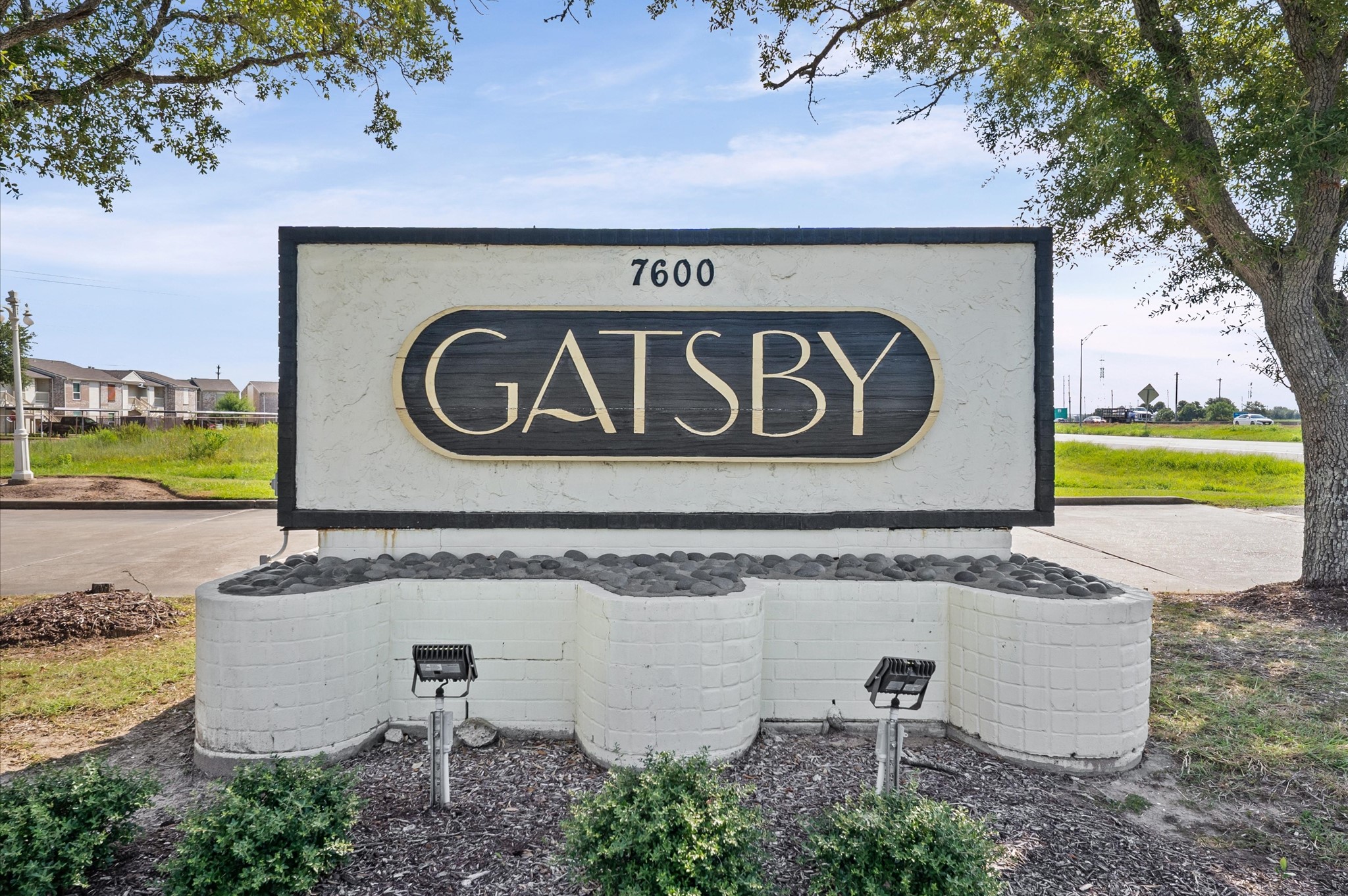 Discover elegance at the Gatsby community, marked by a stylish entrance sign and lush surroundings, offering a welcoming ambiance.
