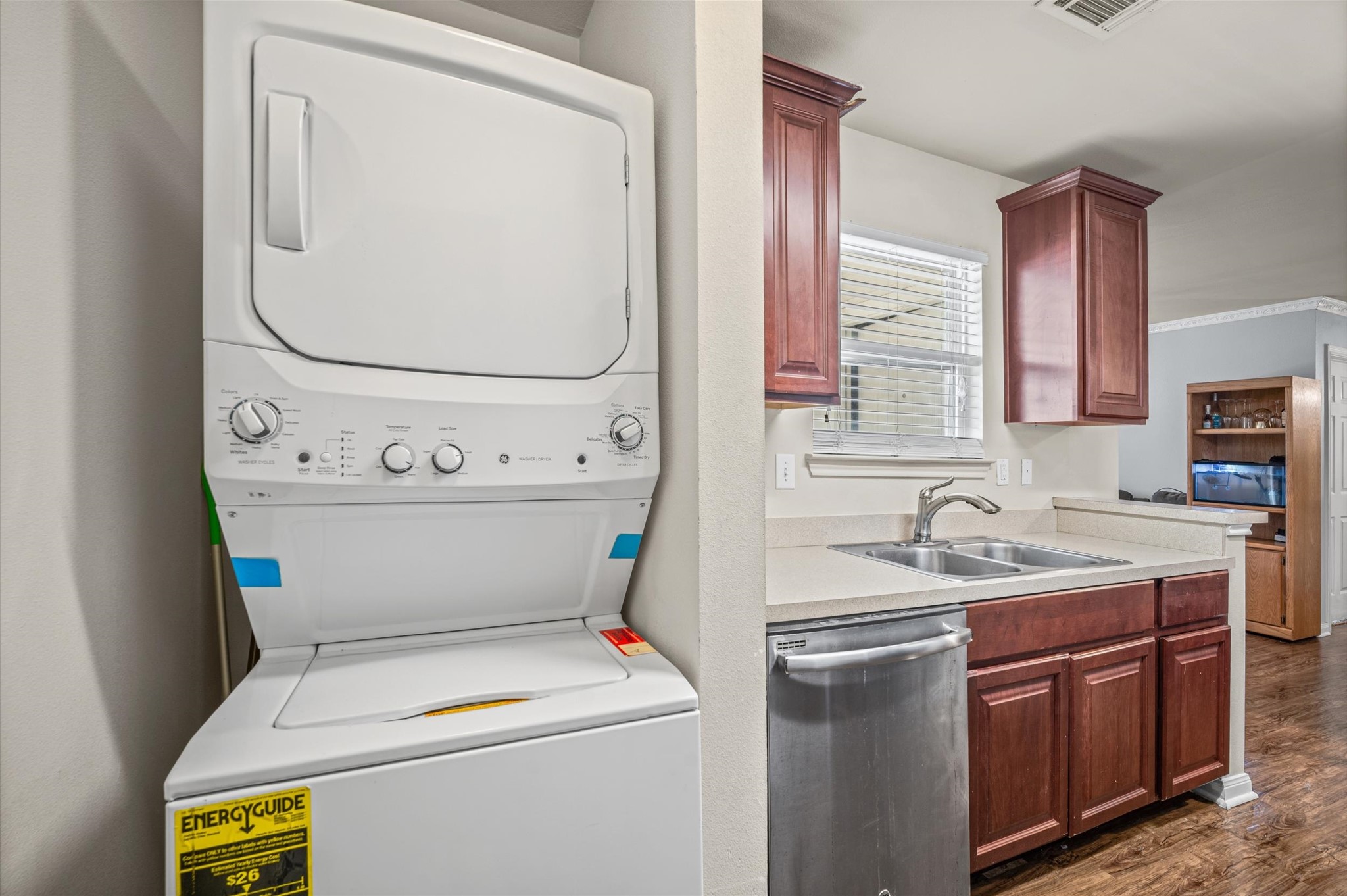 Conveniently located in the kitchen area, a stackable washer and dryer set offers practicality.