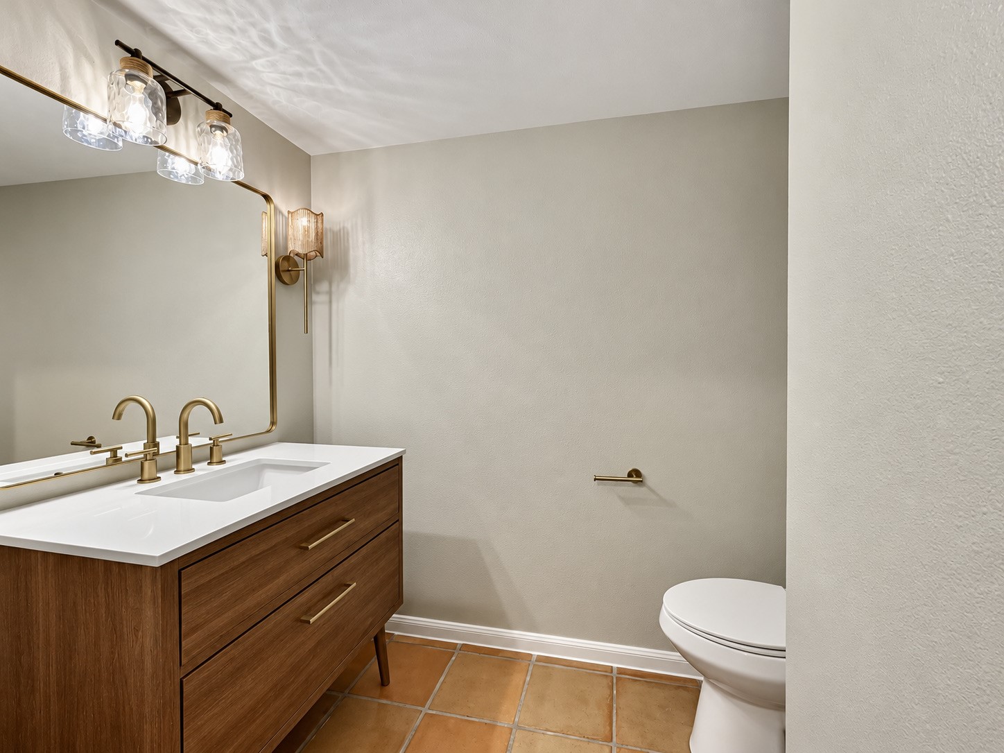 The 1/2 bath received a new vanity, lighting and paint.