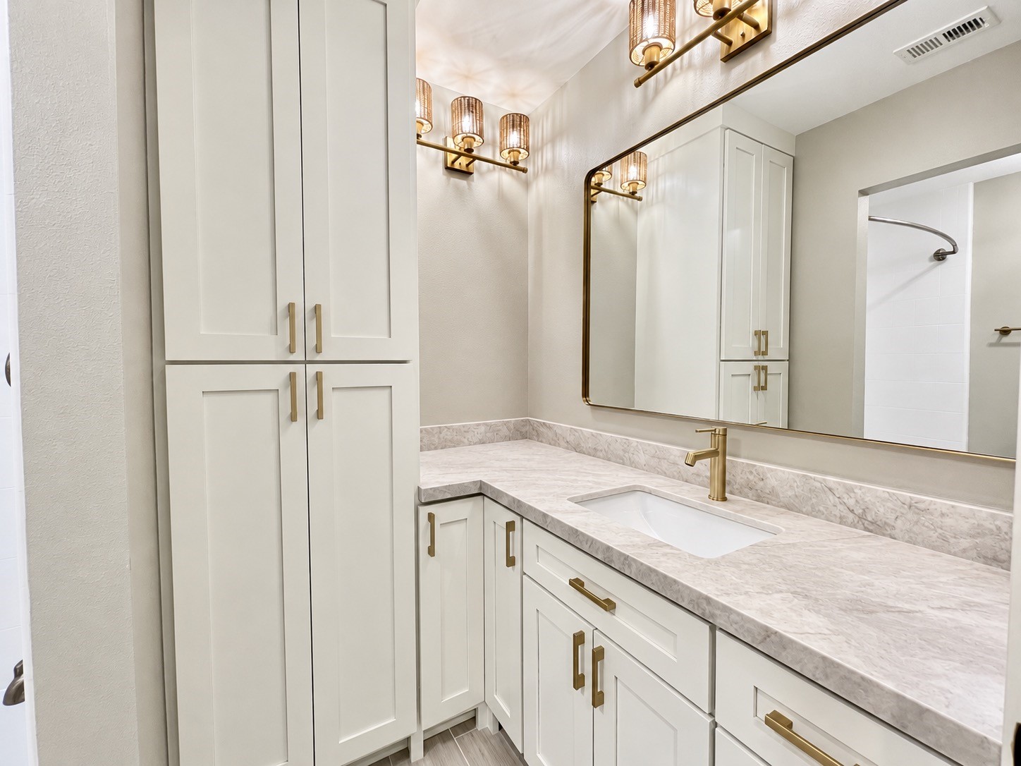 Updated vanity area, with new counters, cabinet fronts and lighting and flooring.