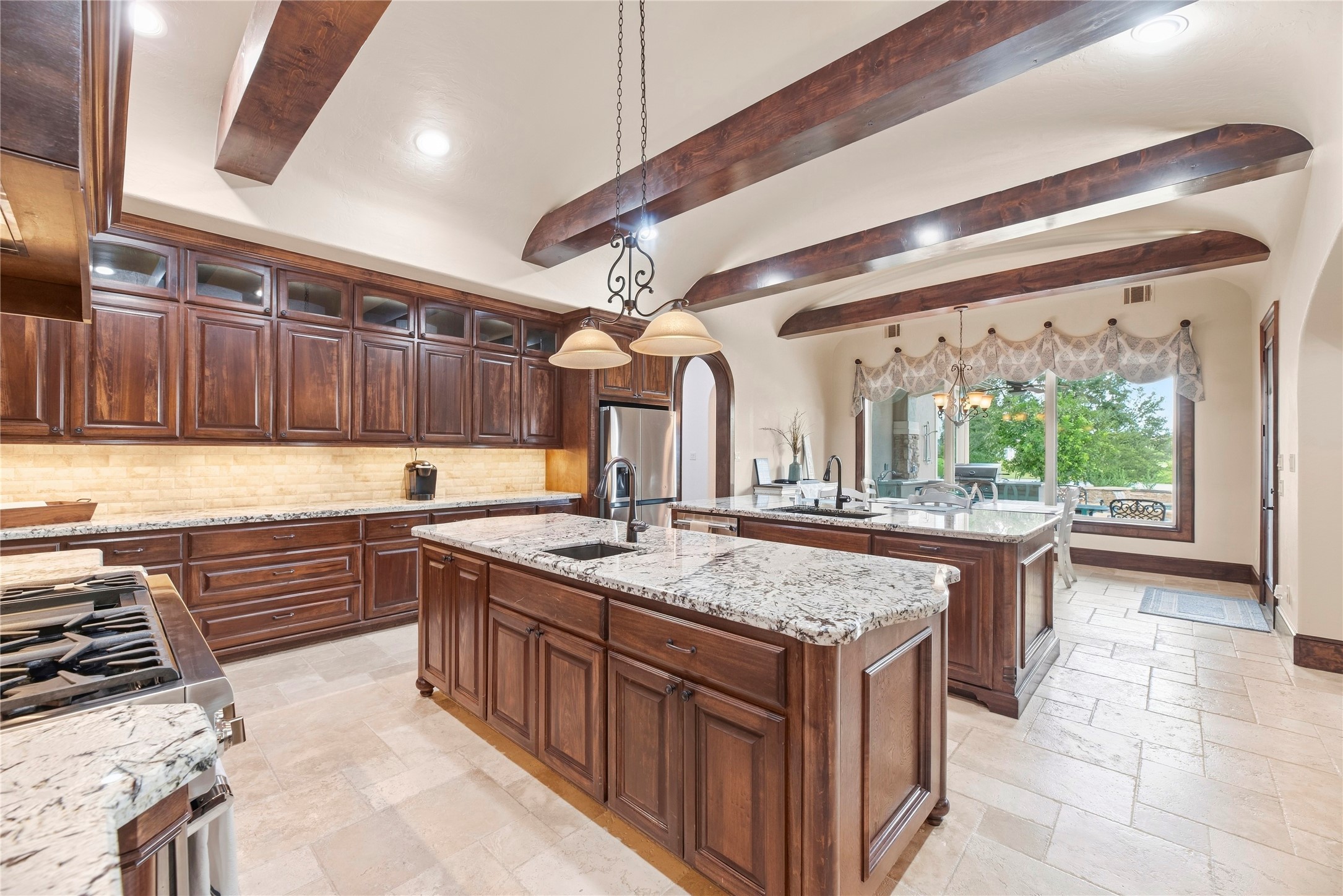 No outlets on that beautiful backsplash, they are under the cabinets with the lighting.