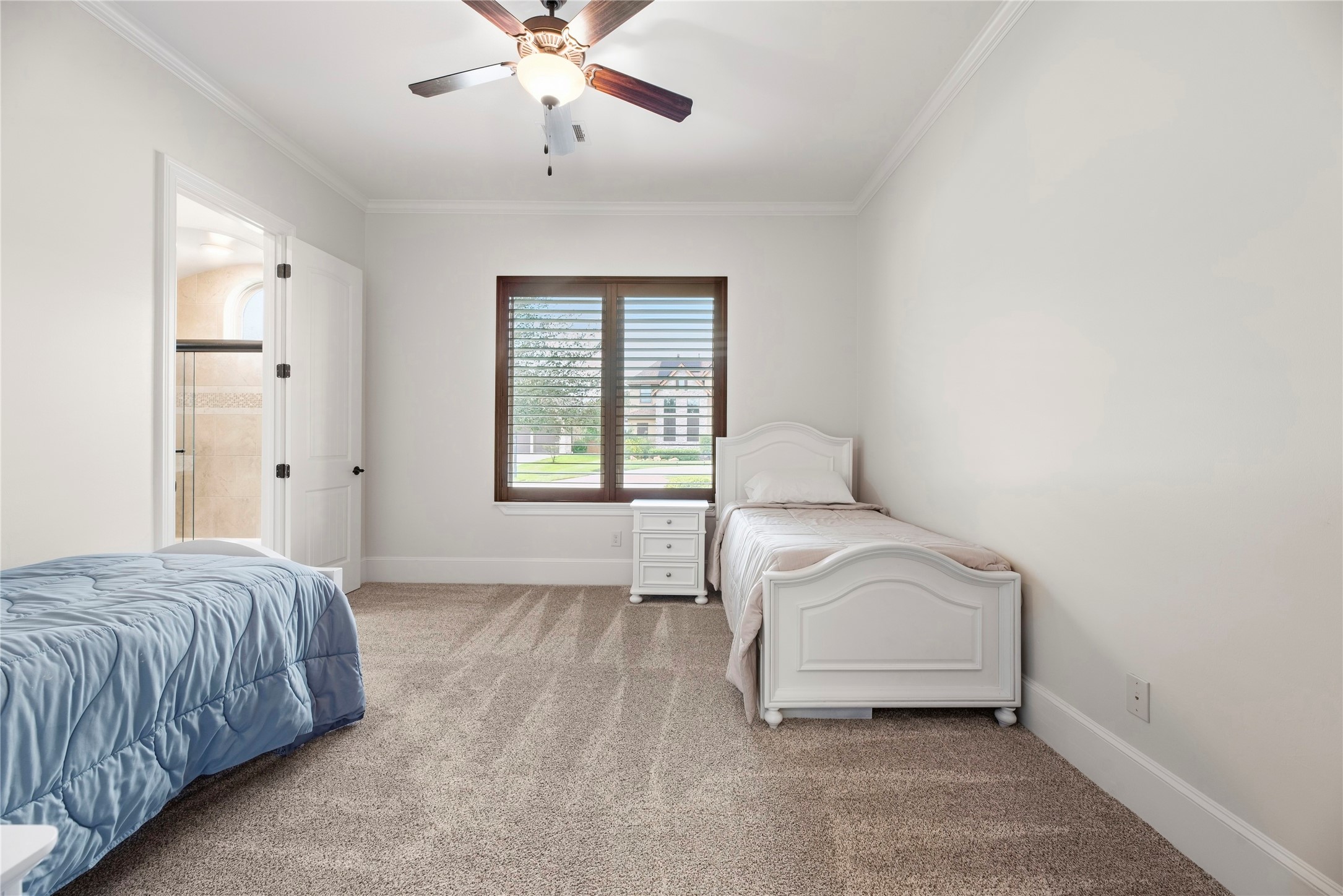 Bedroom 2 downstairs with plantation shutters and recently replaced carpet