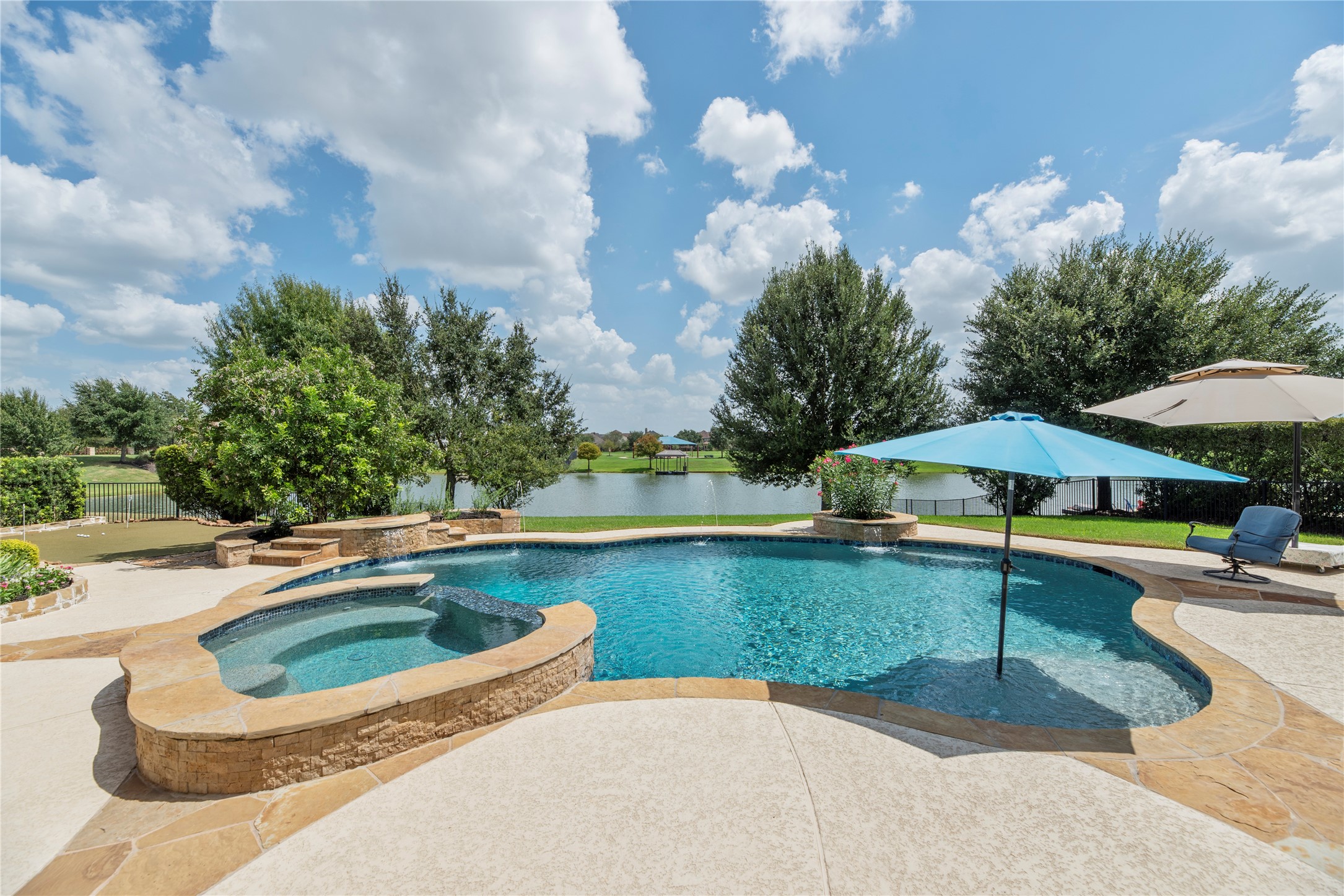 This Stucco and stone beauty is in the private gated section of TowneLake