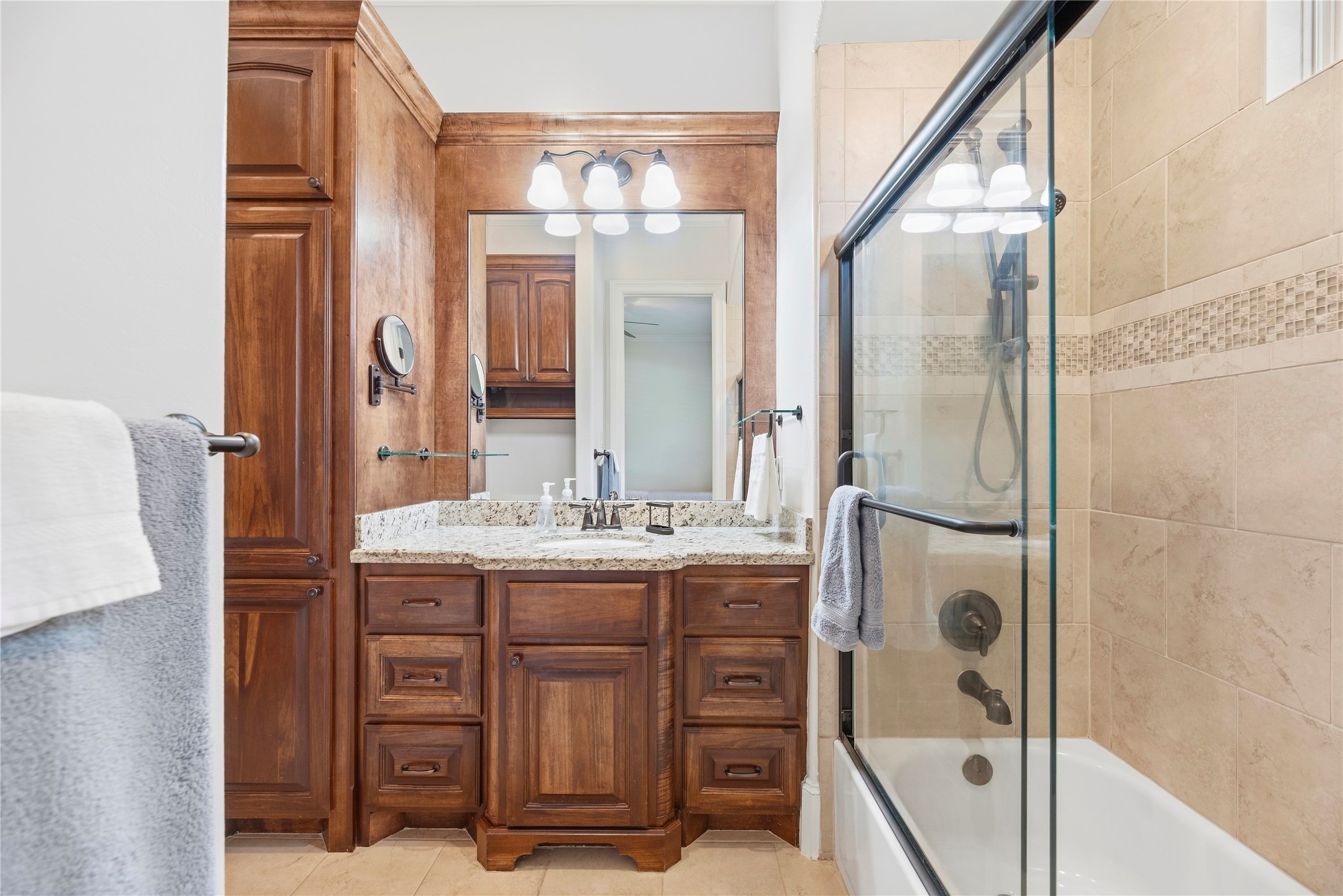 In-suite bath for bedroom 2 with sliding glass doors for the tub & shower