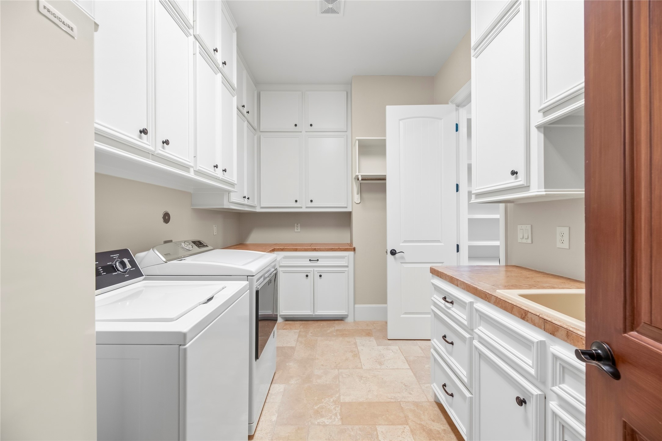 Laundry room with 39 cabinets or drawers, undercabinet lighting and a large sink
