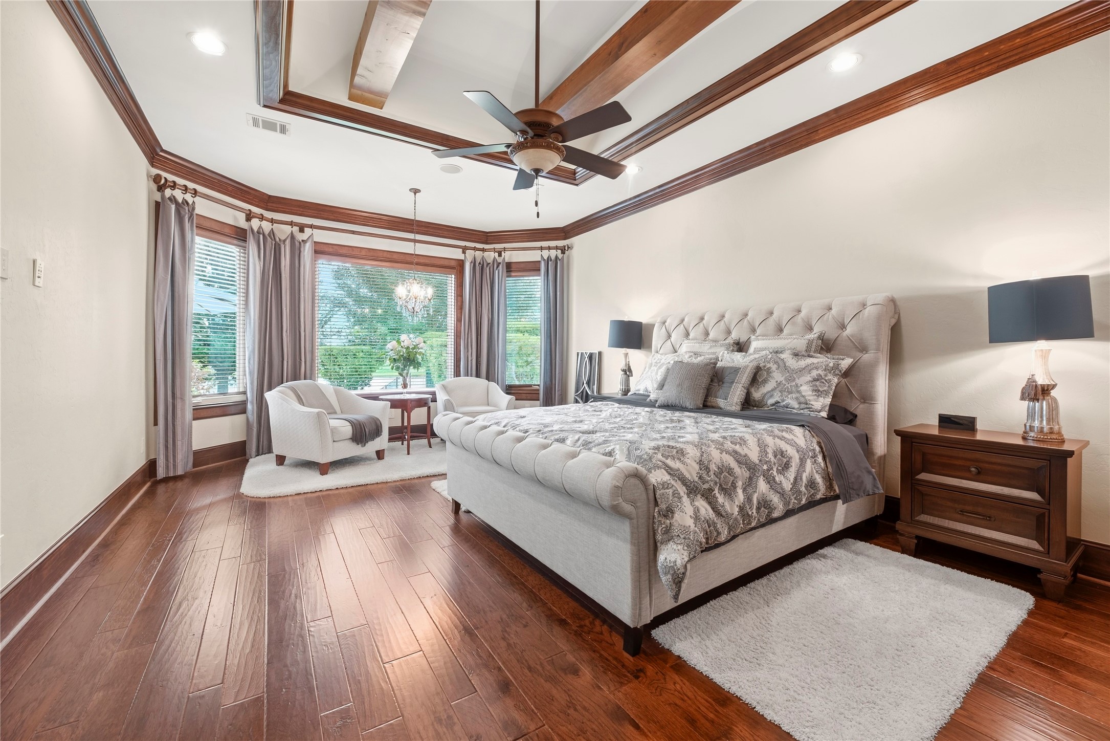 Primary Suite, barrel ceiling, LED up-lighting and sitting area crystal chandelier