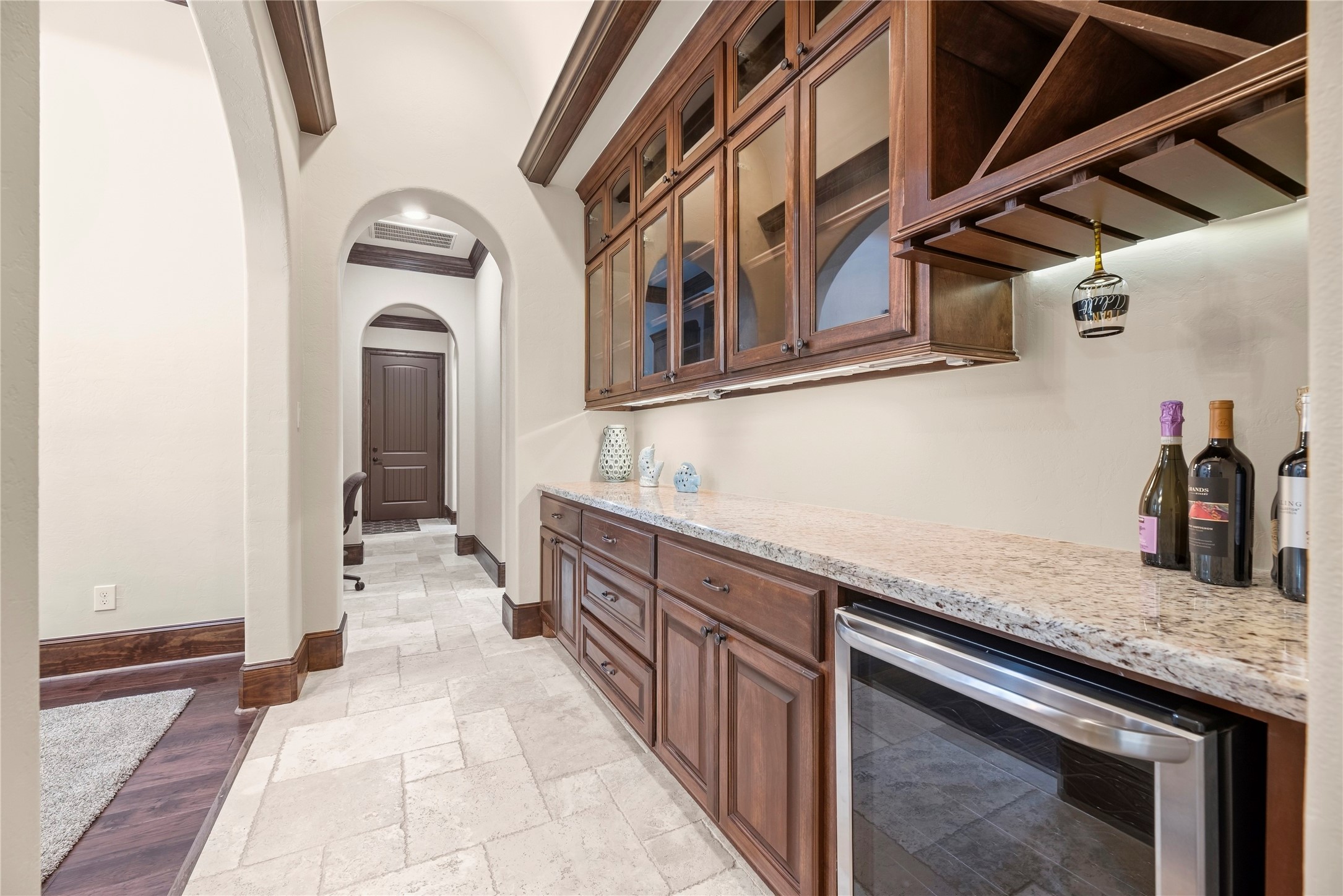 Hallway between Formal dining and Family room with a bar area and wine fridge