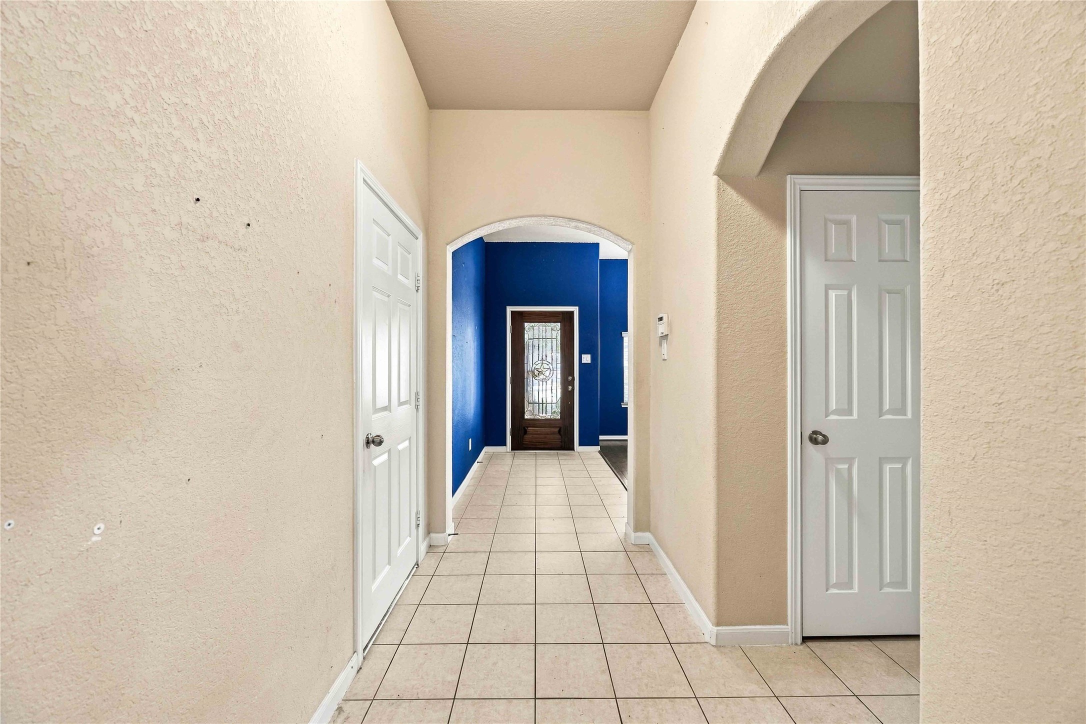 Arched entryway adds character and connects the homes living spaces.