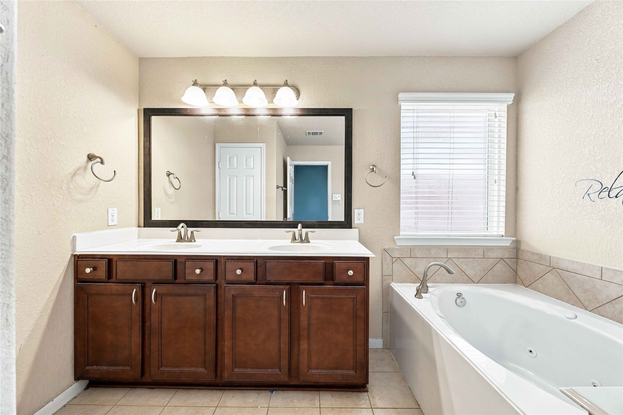 Dual-sink vanity provides plenty of counter and cabinet space.