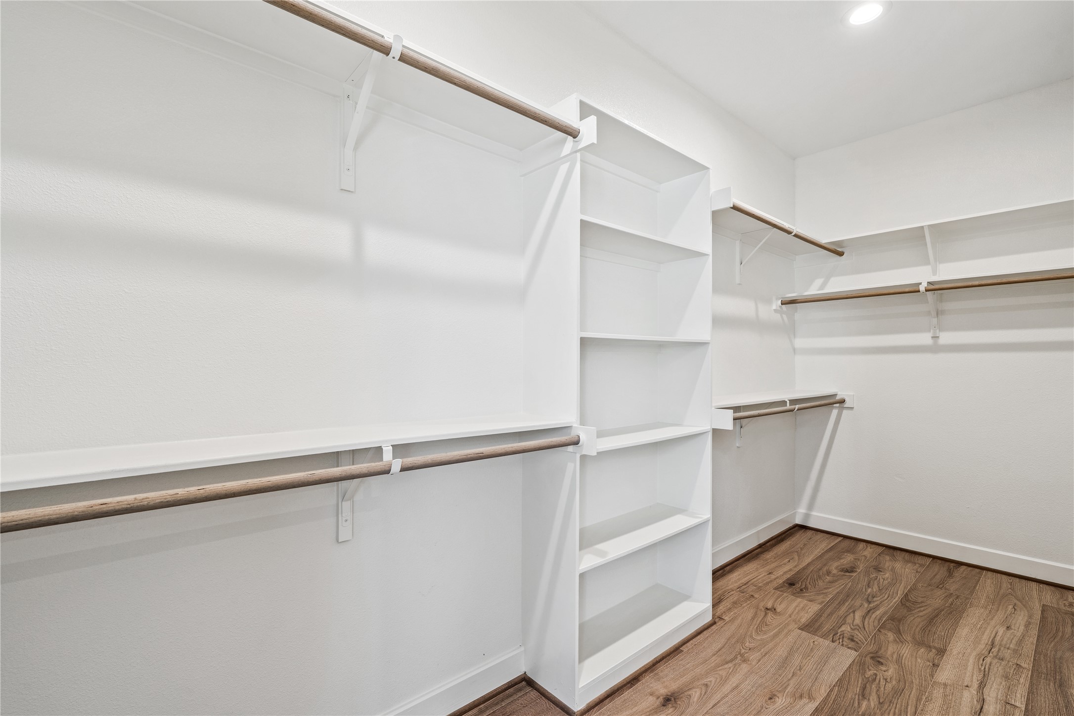 Representative photo showing the communitys model home primary walk-in closet. Layout and selections may vary.