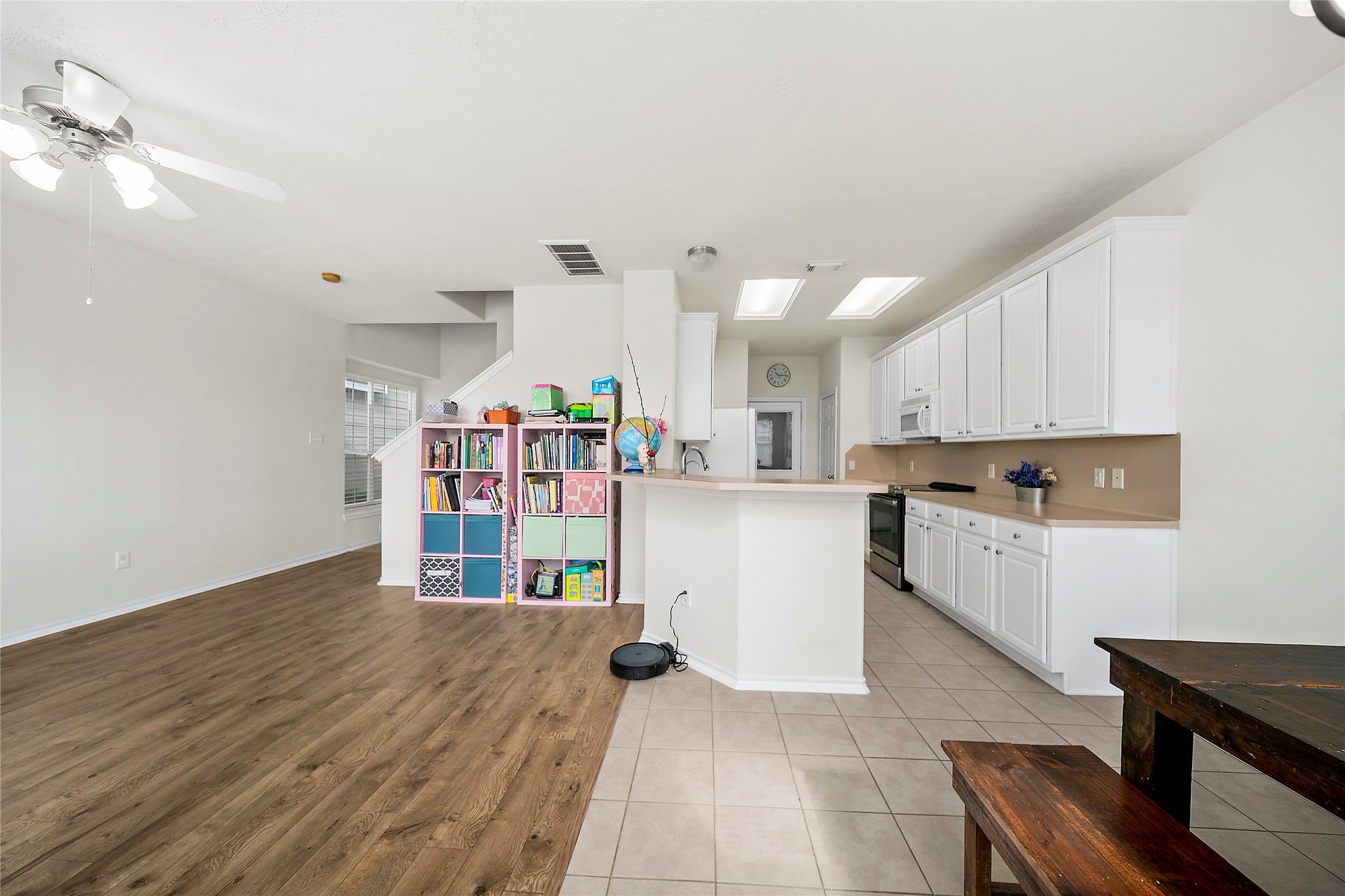 Spacious open floor plan with seamless flow between living and kitchen areas, featuring abundant natural light and modern finishes.