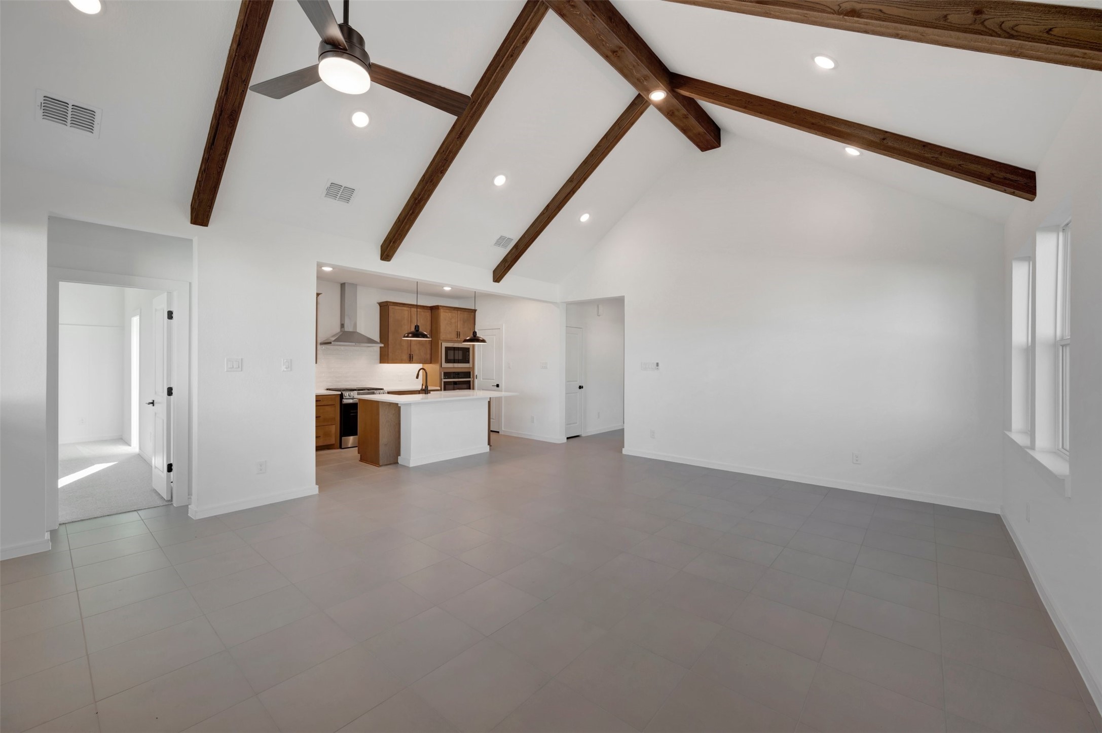 Impressive living area with stained beams on the vaulted ceilings