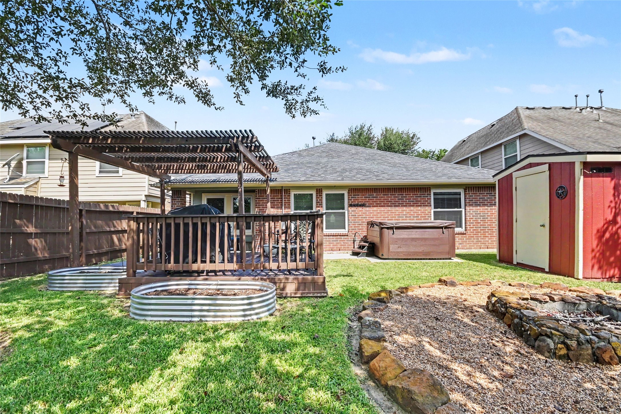 This backyard is your own private playground, you have some raised garden beds, a hot tub, deck and a firepit