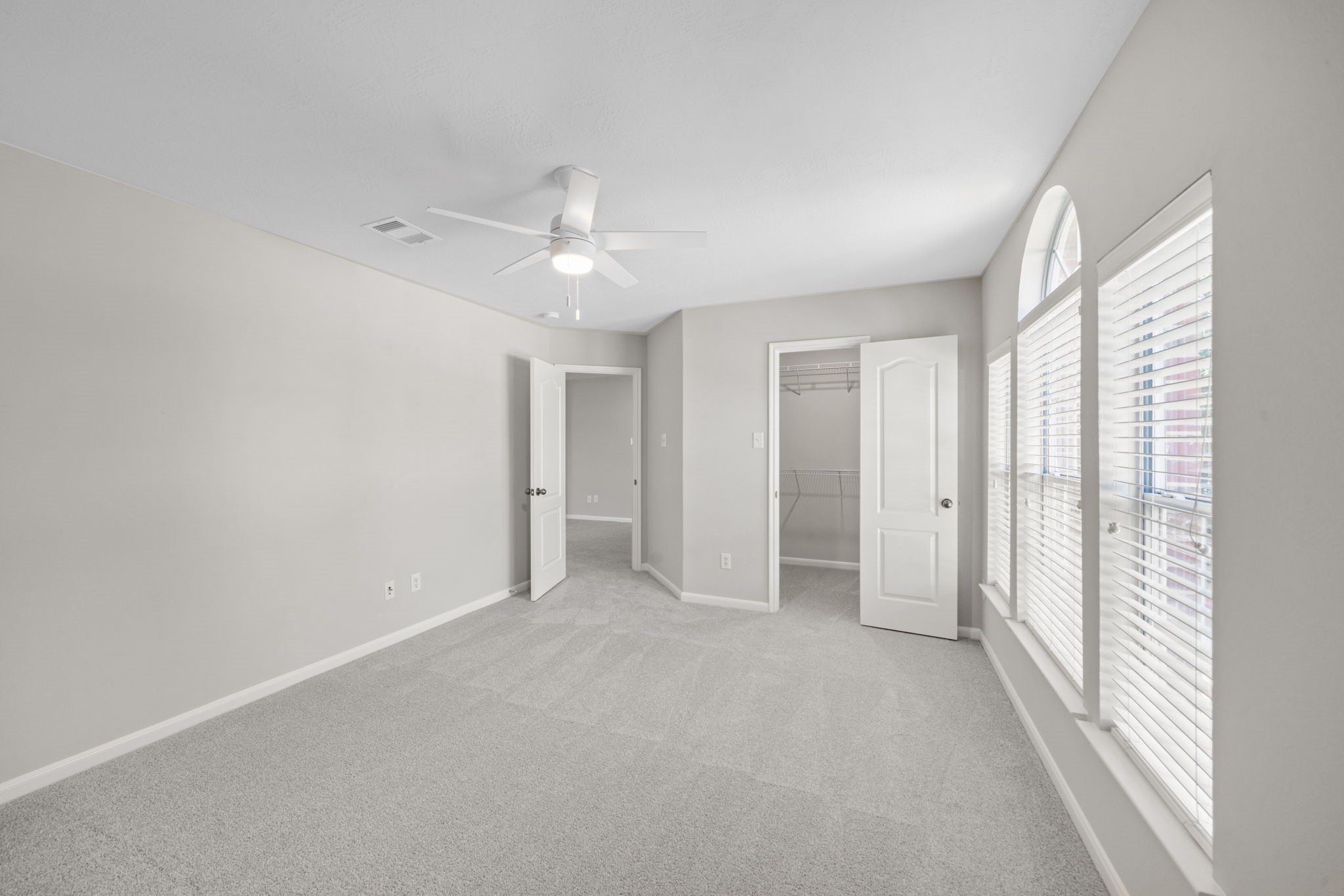 Large fifth bedroom with oversized windows.