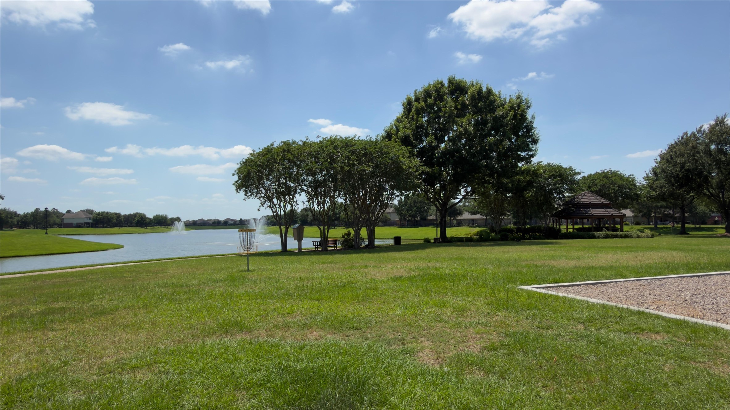 Scenic walking paths and green spaces around the lake.