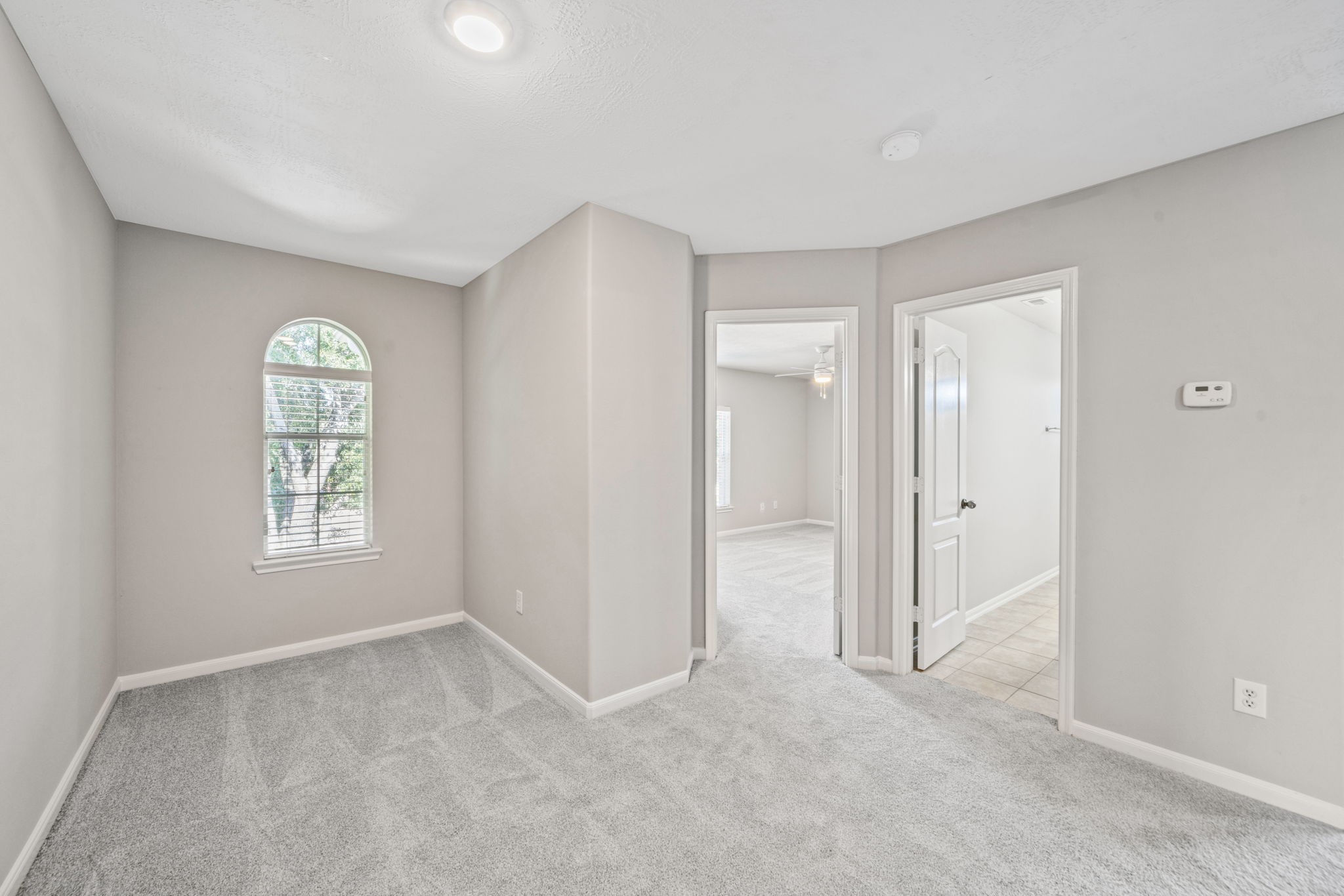 Spacious fourth bedroom with abundant natural light.