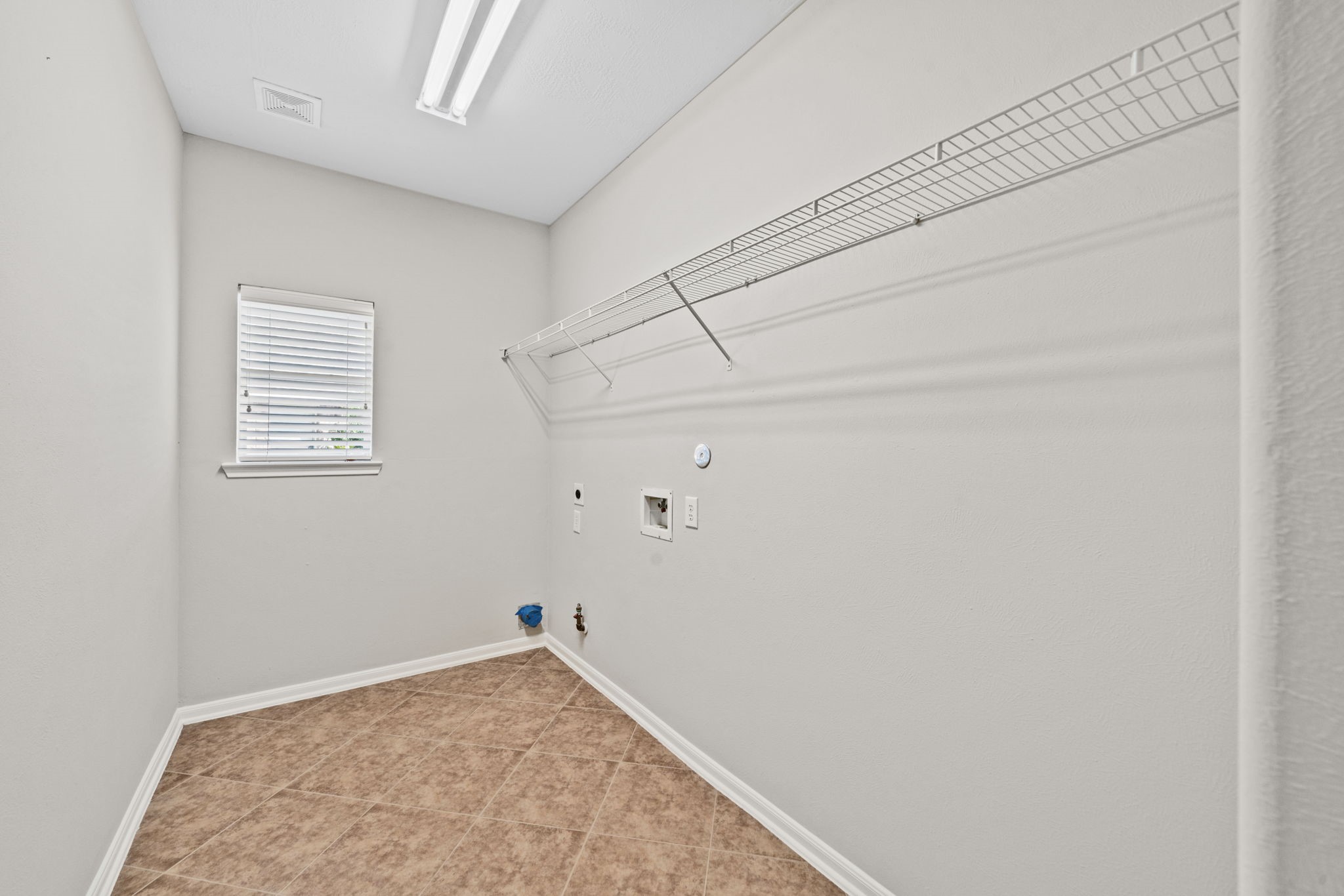 Spacious laundry room with extra storage area.