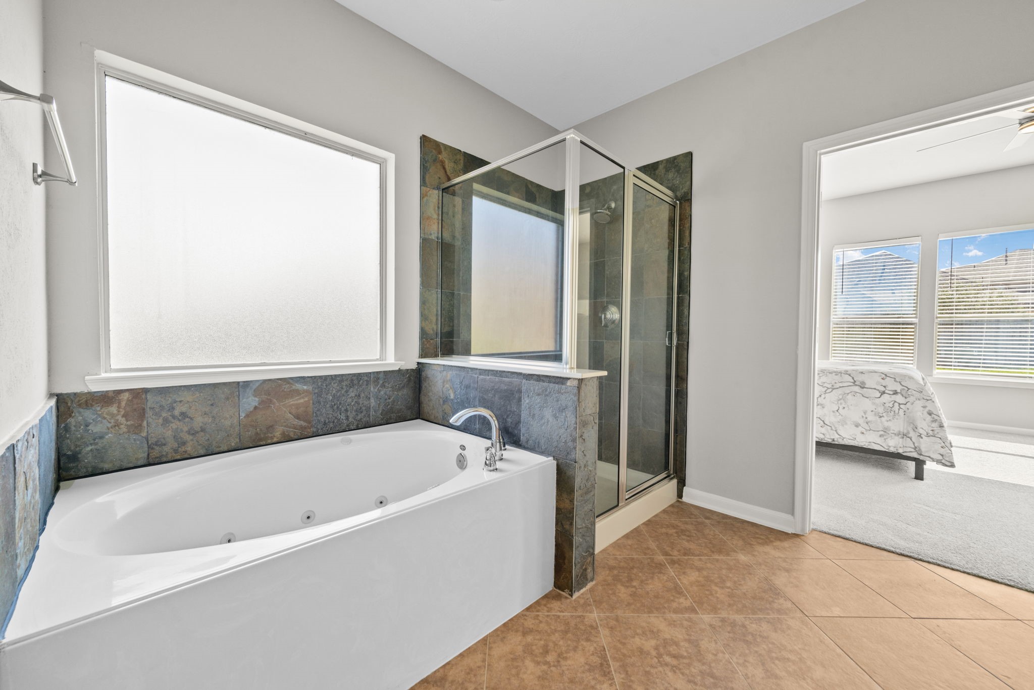 Primary bath featuring soaking tub and separate shower.