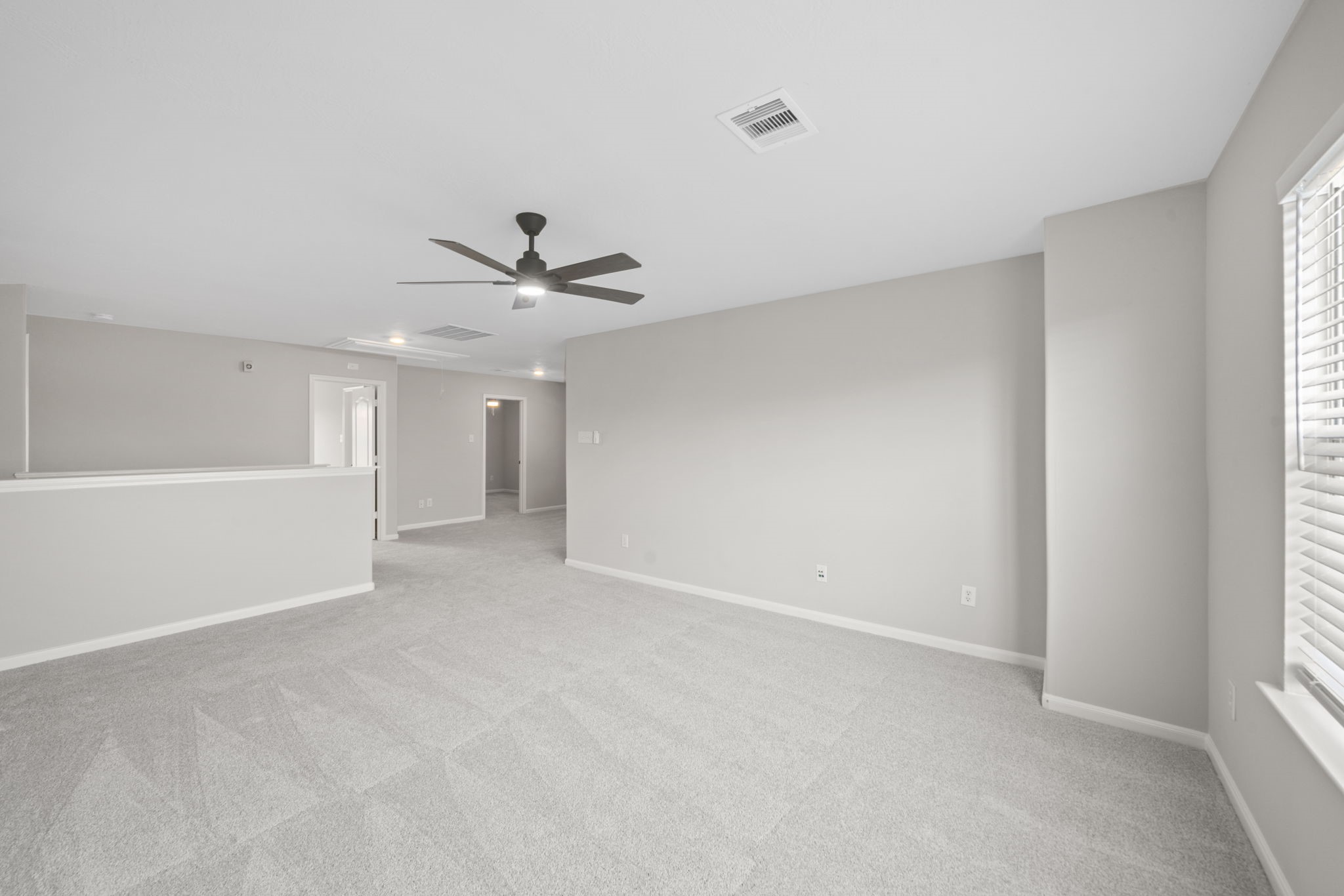 Spacious upstairs game room perfect for entertaining or movie nights.