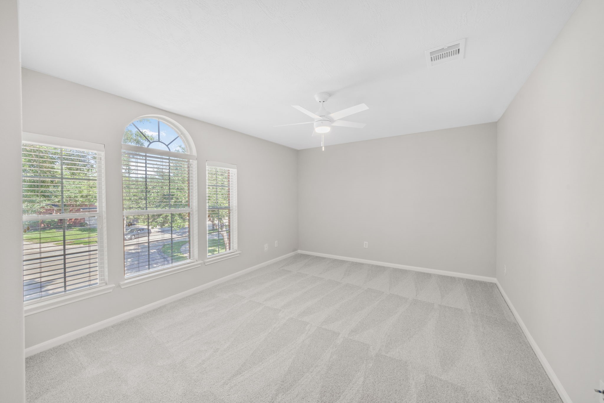 Bright upstairs bedroom overlooking the backyard.