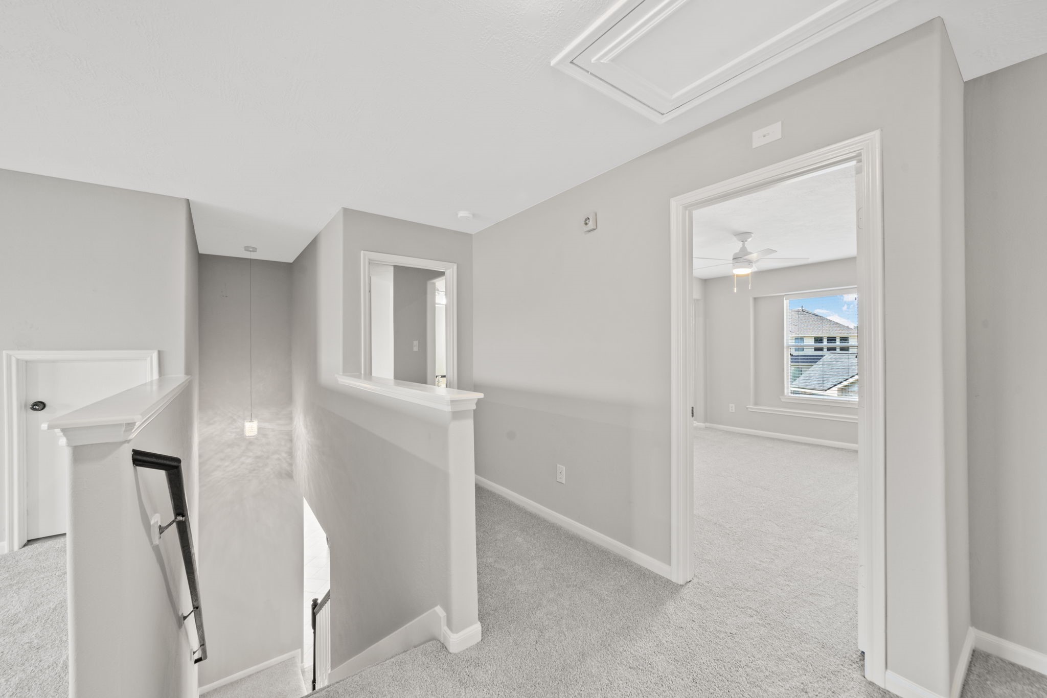 Open upstairs hallway with elegant architectural details.