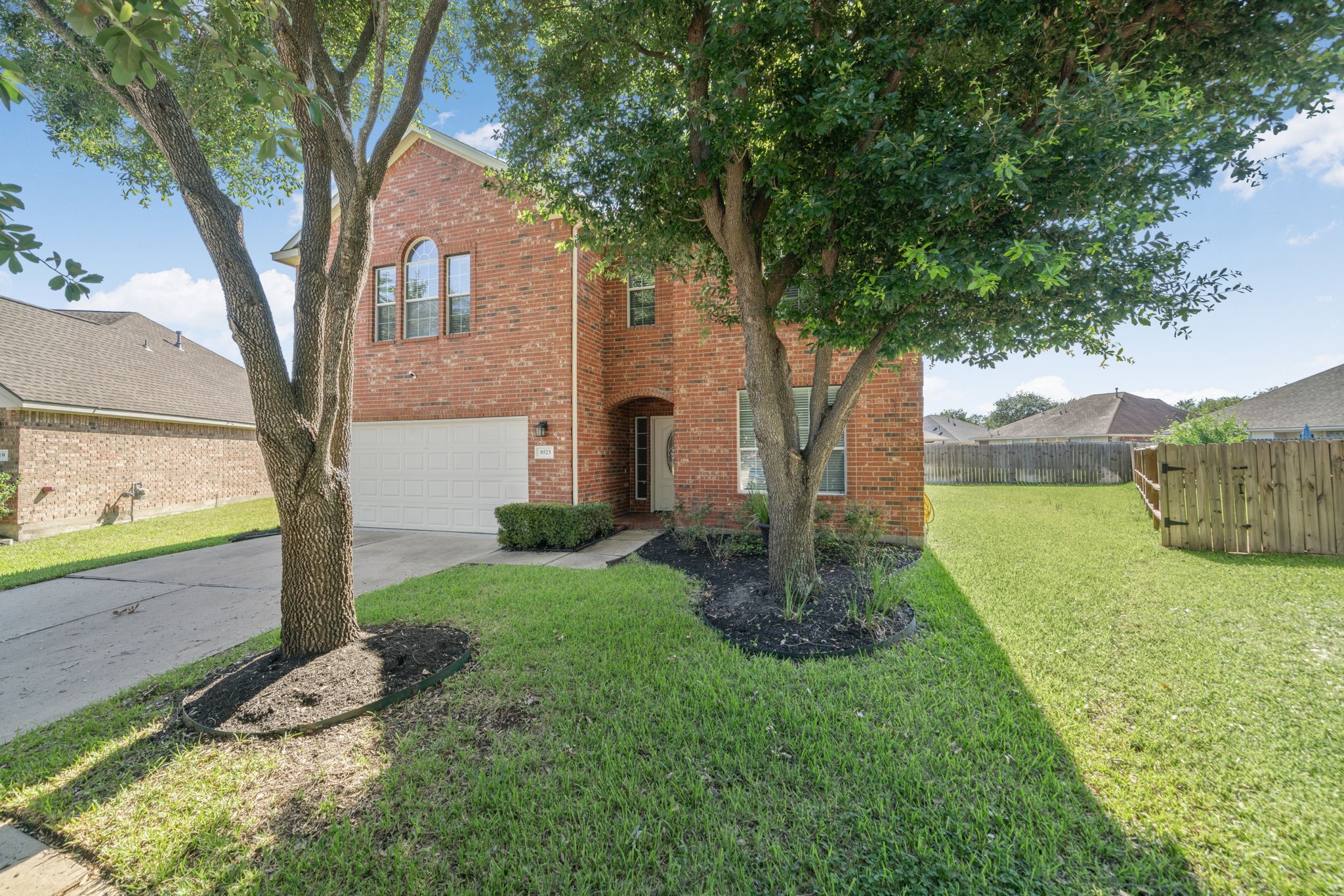 Large corner-style lot with mature trees and extra outdoor space.