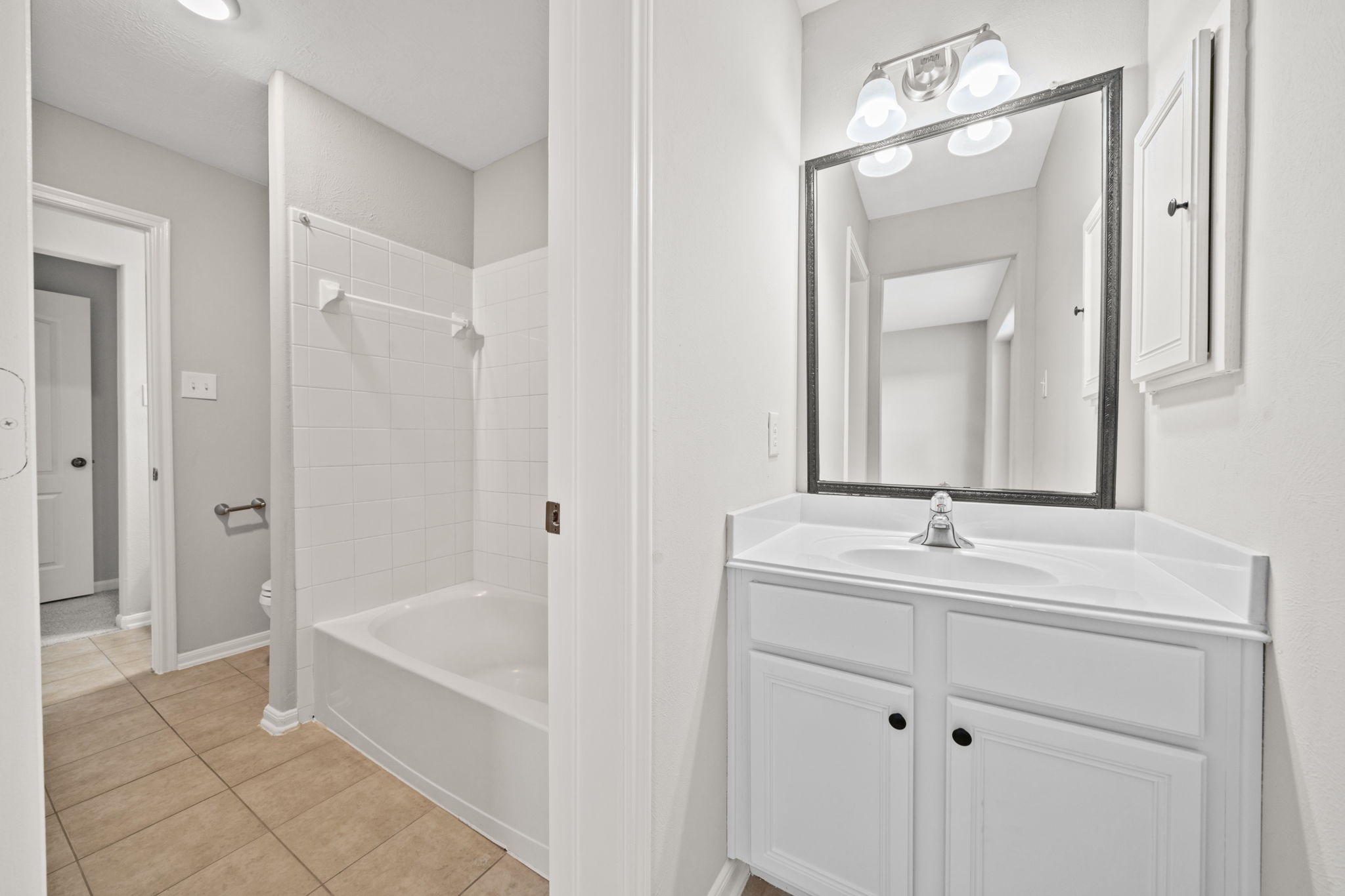 Hollywood-style bathroom with private vanity area.