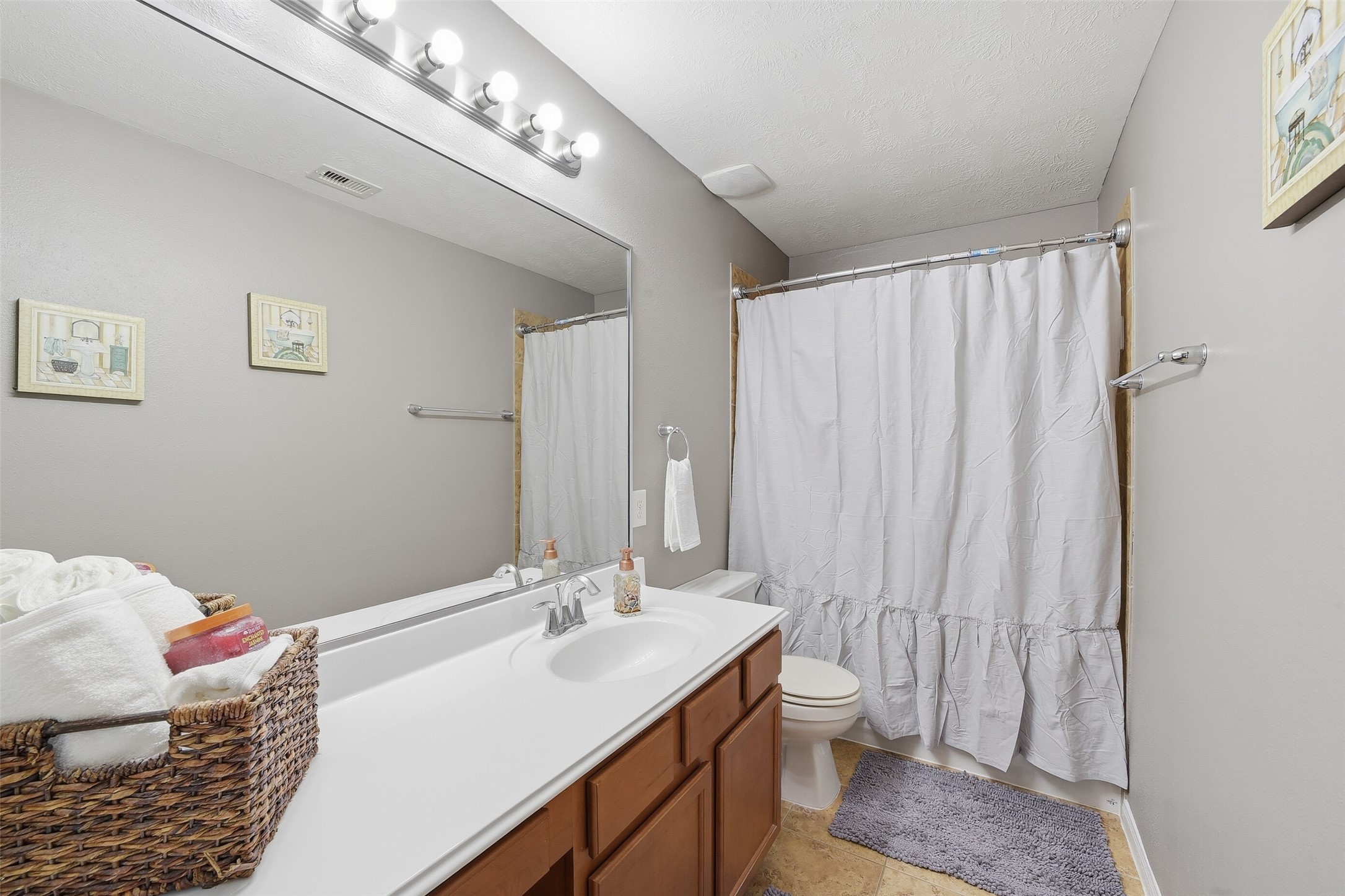 FULL Bathroom #3 situated just outside of Bedrooms #3 & #4 offers an extended counter w/vanity