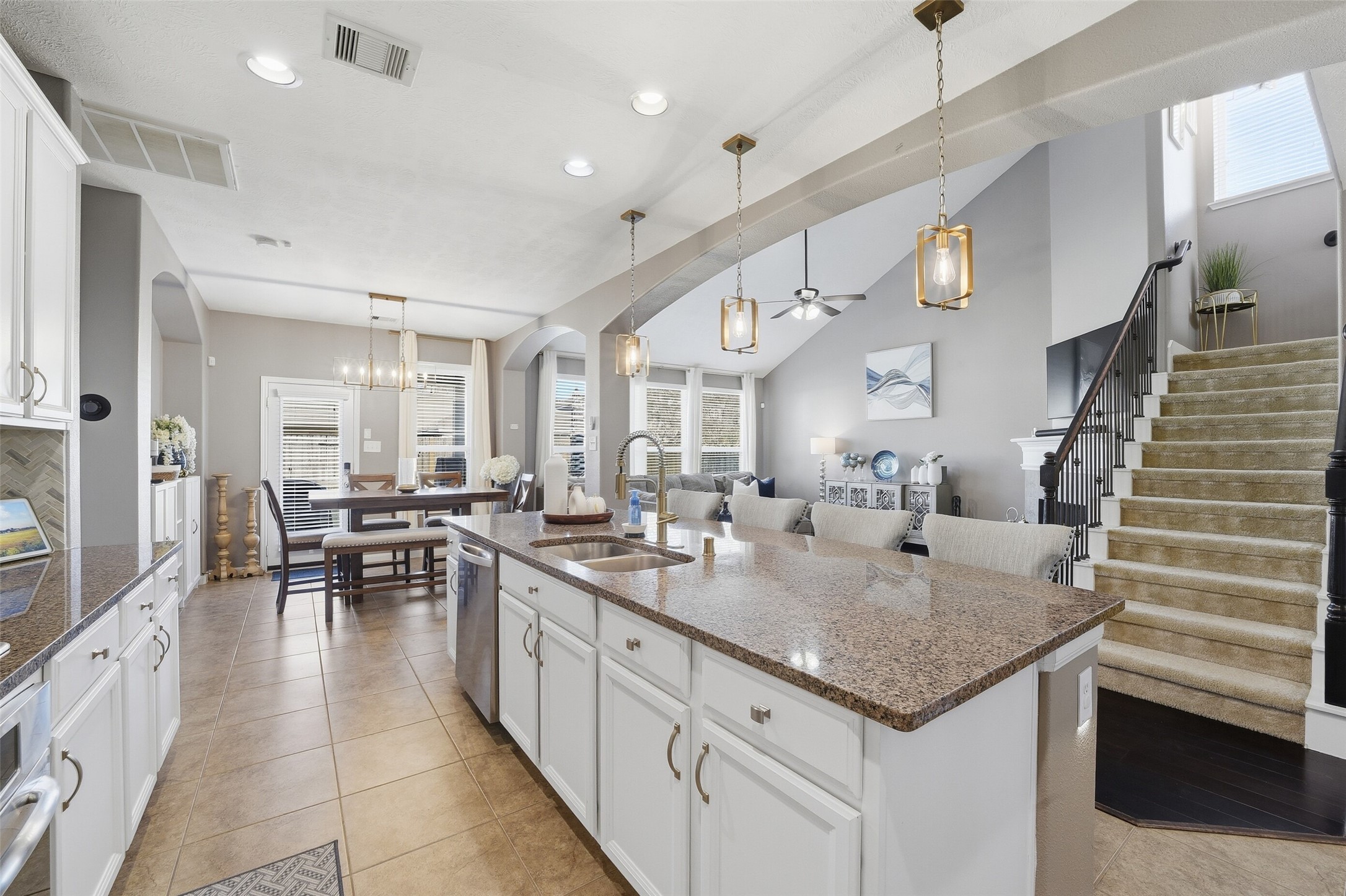 Natural light fills the space! There is also a half bathroom conveniently located next to the stairs. It offers a large storage closet under the stairs too!