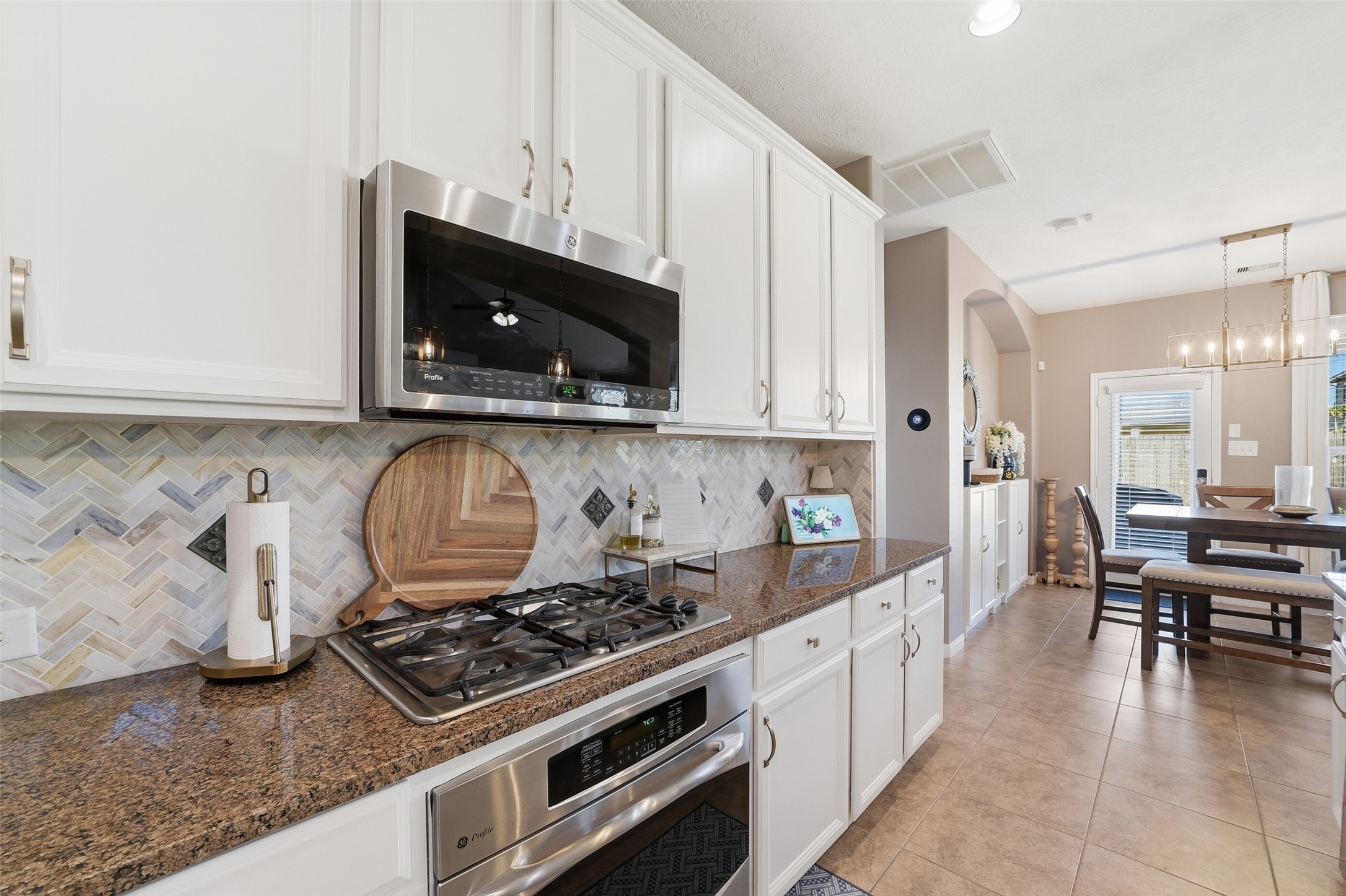 Elegant tile backsplash, expansive counters & built-in appliances make cooking a breeze!