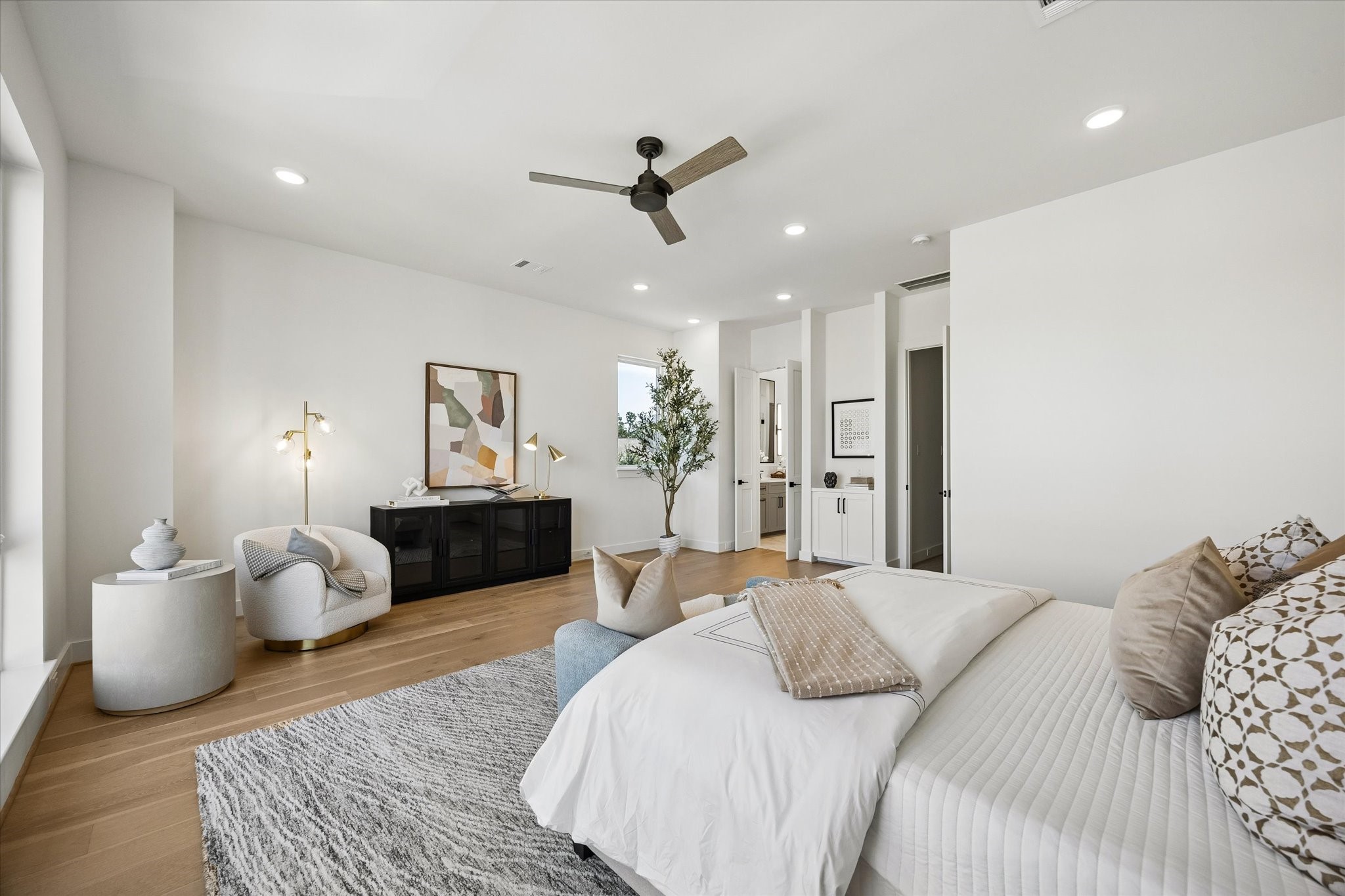 Another view of this light and bright primary suite. Just before you enter the primary bathroom, there is a built-in nook that offers the perfect spot for a coffee bar or extra storage. From the right window, you have the perfect view of Downtown! Expansive room offers space for a sitting area!